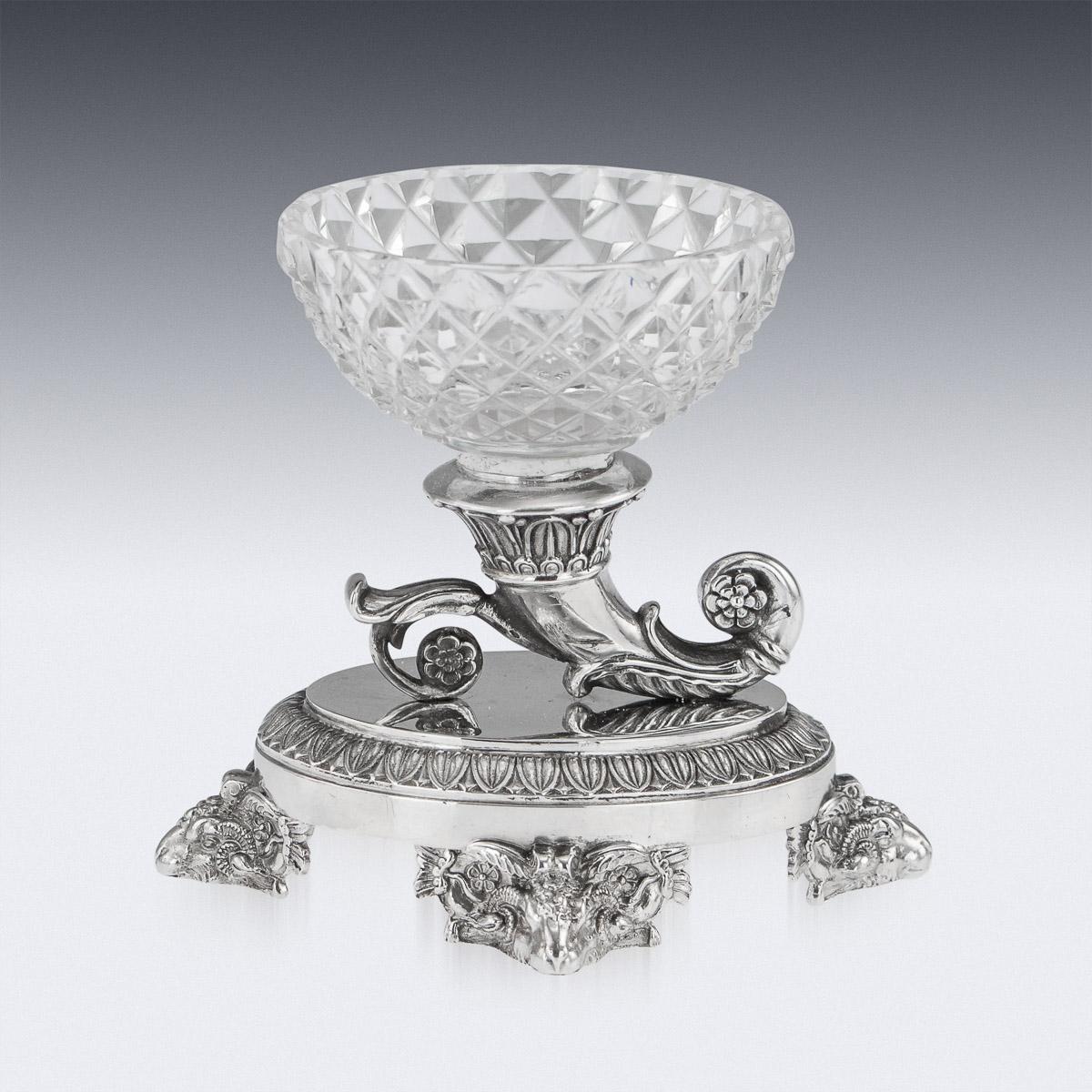 Antique early-19th Century French Empire solid silver & cut crystal condiments service, consisting of two condiments servers, one with covers and 6 salts. Beautifully decorated with laurel leaf boarders, laurel garland shaped handles and cut crystal