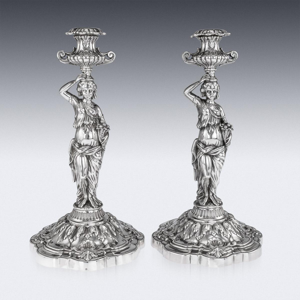 Antique 19th century French solid silver candlesticks, exceptionally large and heavy gauge, each on shaped-quatrefoil base and embellished with shells and leaves, the cast supporting figures depicting the Goddess Demeter, the Olympian goddess of the
