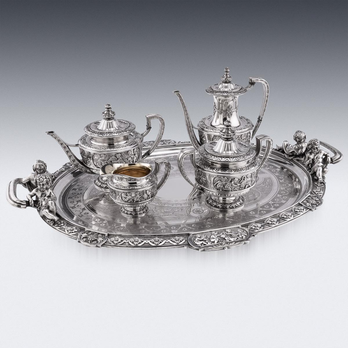 19th Century French silver tea & coffee service on tray, comprising of a coffee pot, teapot, sugar bowl, cream jug and large oval tray. Each piece with panel reserves, cast as putto in various pursuits, the tray handles capped with cast reclining