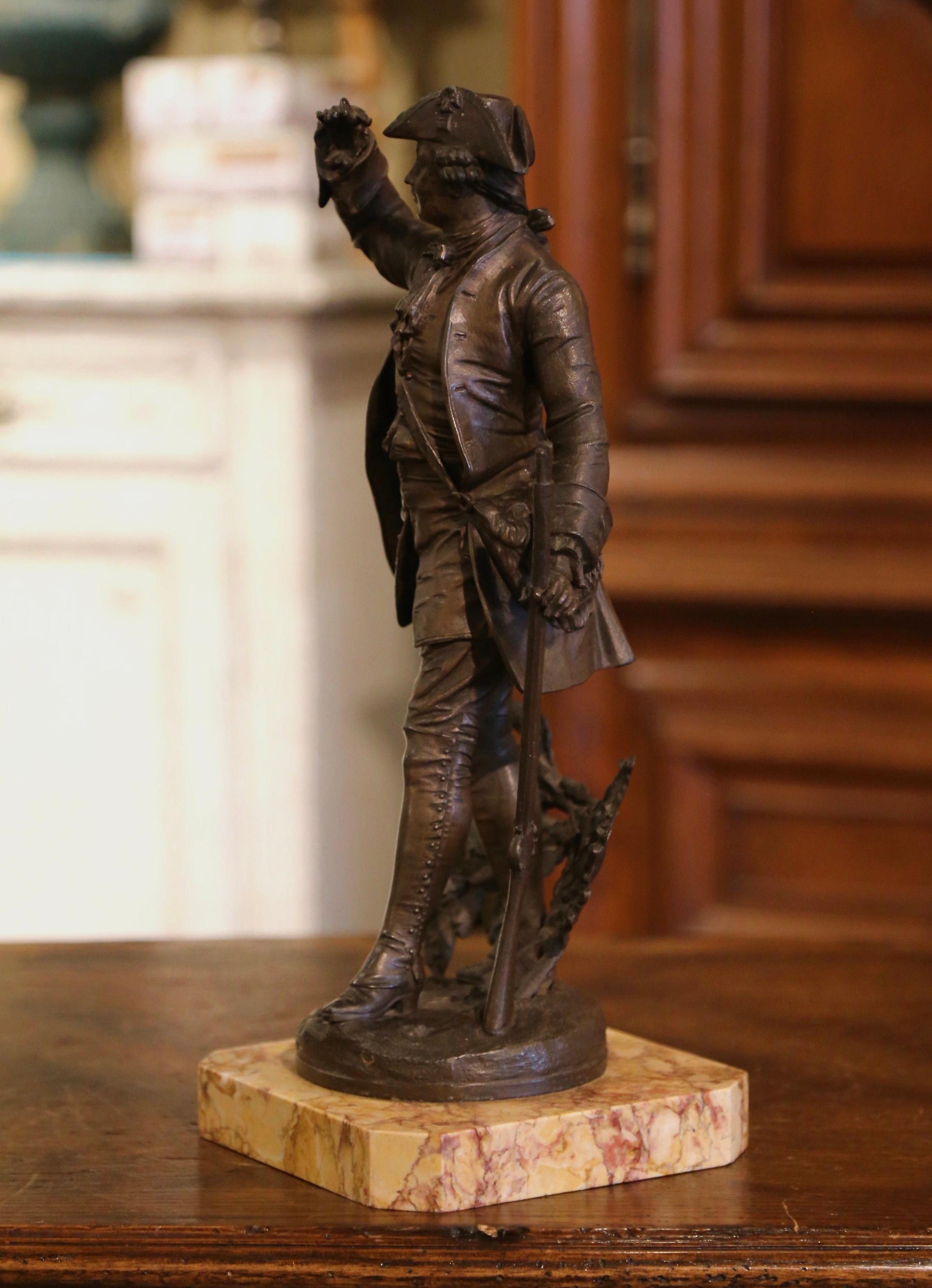 Decorate a gentleman's study or office with this antique figure. Sculpted in France, circa 1880, the spelter statue stands on a variegated beige marble base, and depicts a soldier in Louis XV clothing holding a gun in his left hand while scanning