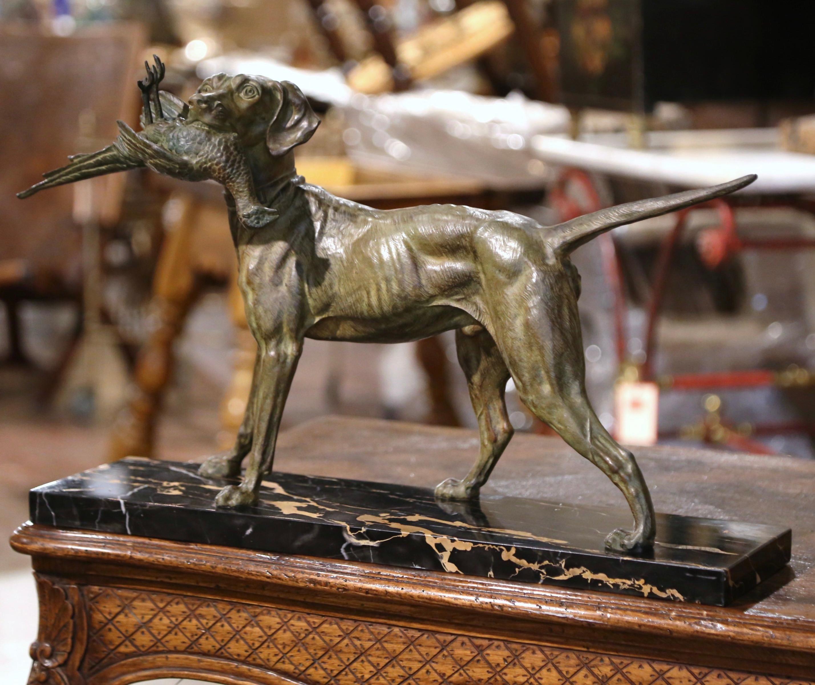 Decorate a man's office or library with this antique dog and bird sculpture composition. Created in France circa 1870, and standing on a rectangular marble base, the sculpture depicts a hunting setter holding a pheasant in his mouth; the composition