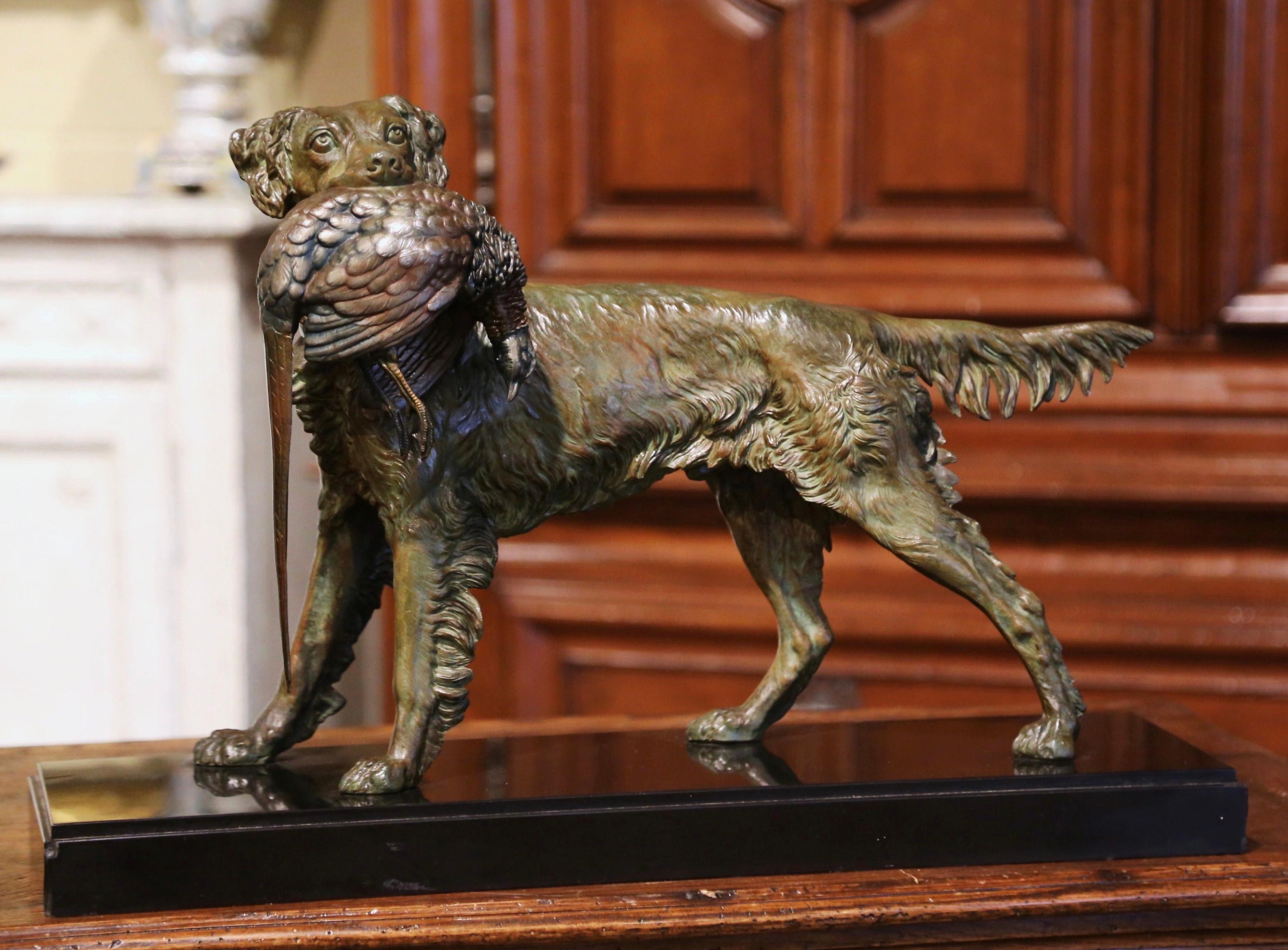 Decorate a man's office or library with this antique dog and bird sculpture with two tones finish. Created in France circa 1870, and standing on a black marble base, the sculpture composition depicts a hunting setter holding a pheasant in his mouth.