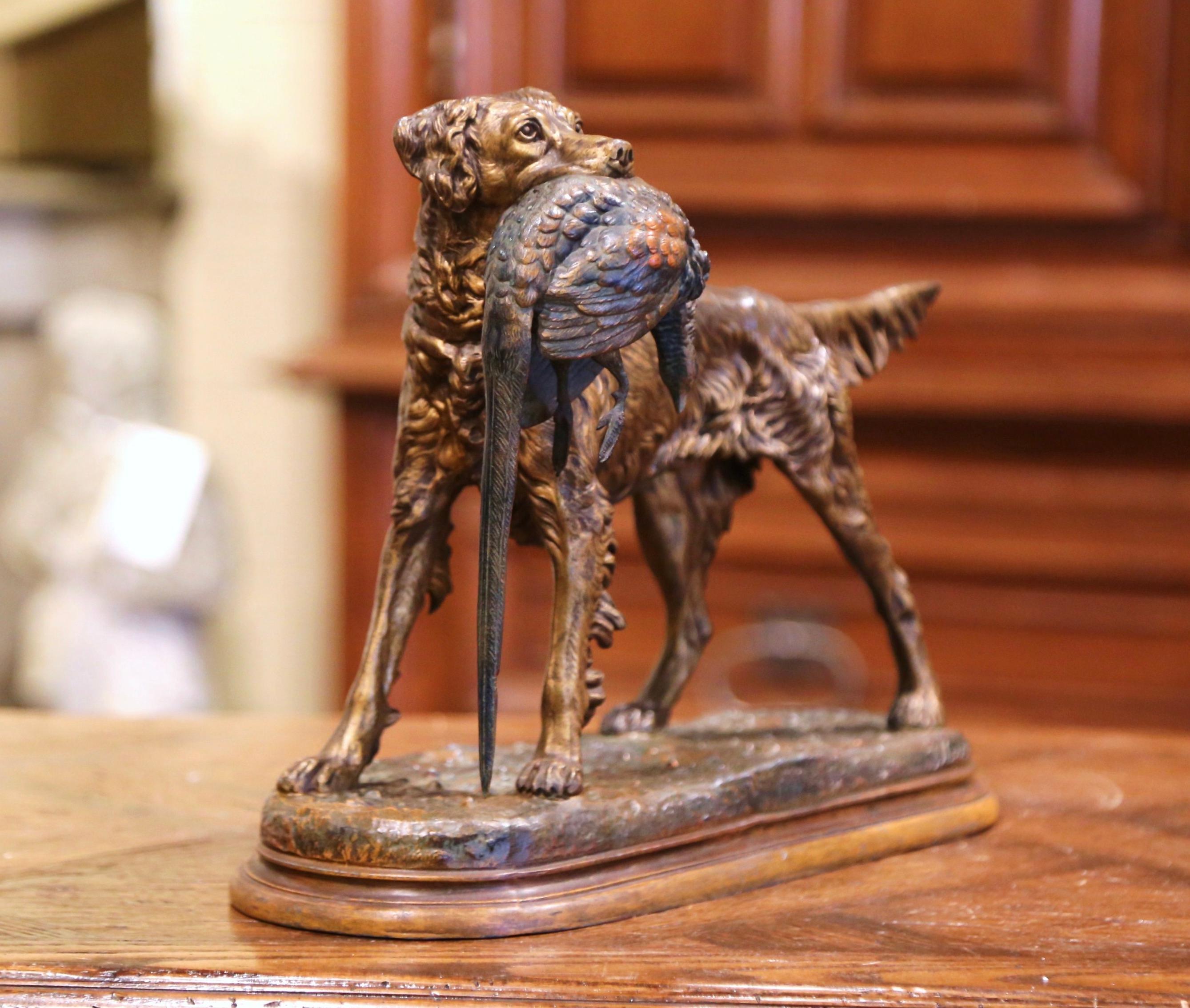 Decorate a man's office or study with this antique dog and bird sculpture with two tones finish. Created in France circa 1870 in the style of Jules Moigniez, the spelter sculpture composition depicts a setter standing on a flat base and holding a