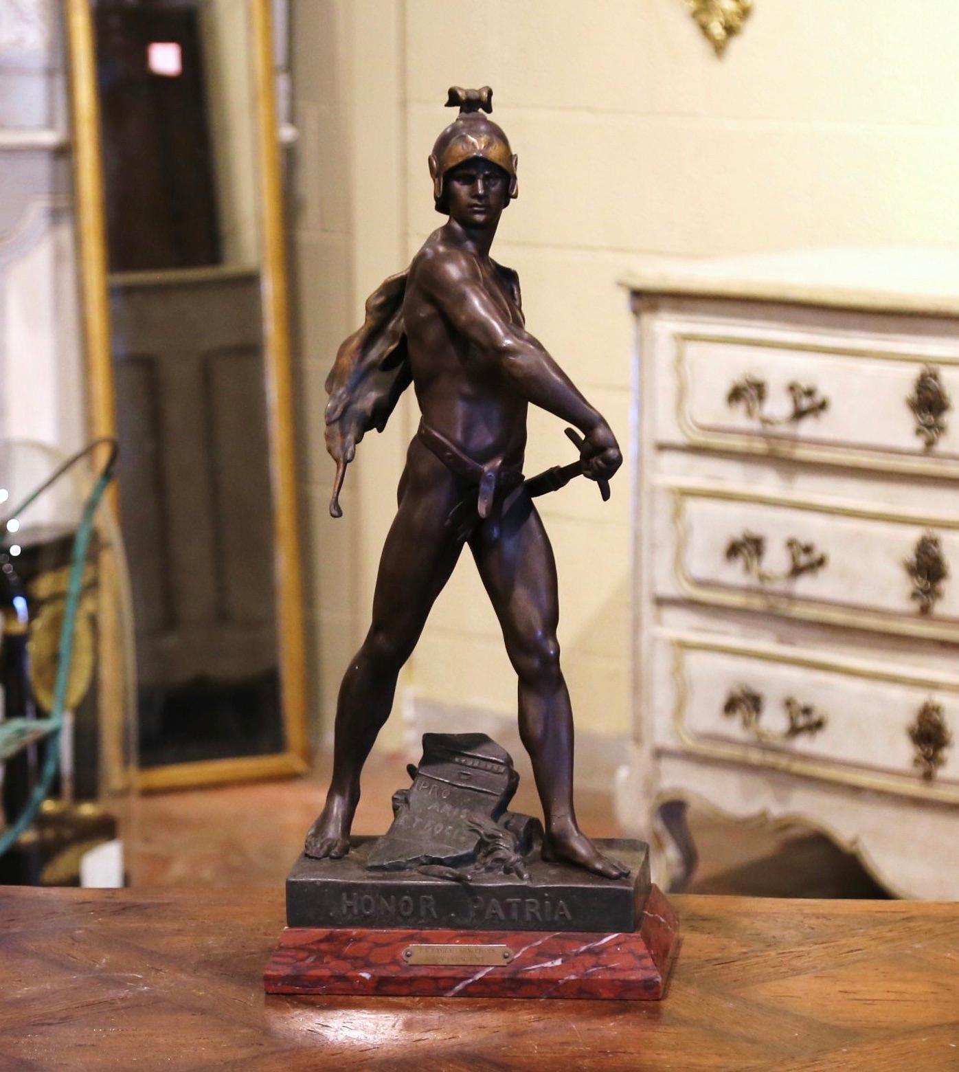 Decorate a gentleman's study or l’office with this antique figure. Sculpted in France, circa 1880, the spelter statue stands on a red marble base, and depicts a Roman soldier holding a sword. The statue titled 