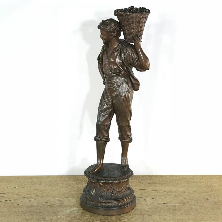 19th century French Spelter statue depicts a grape harvester in a classical pose. The revival of the style that originated in ancient Greece and Rome was a hallmark of the latter half of the 19th century, but it has enjoyed revivals in pretty much