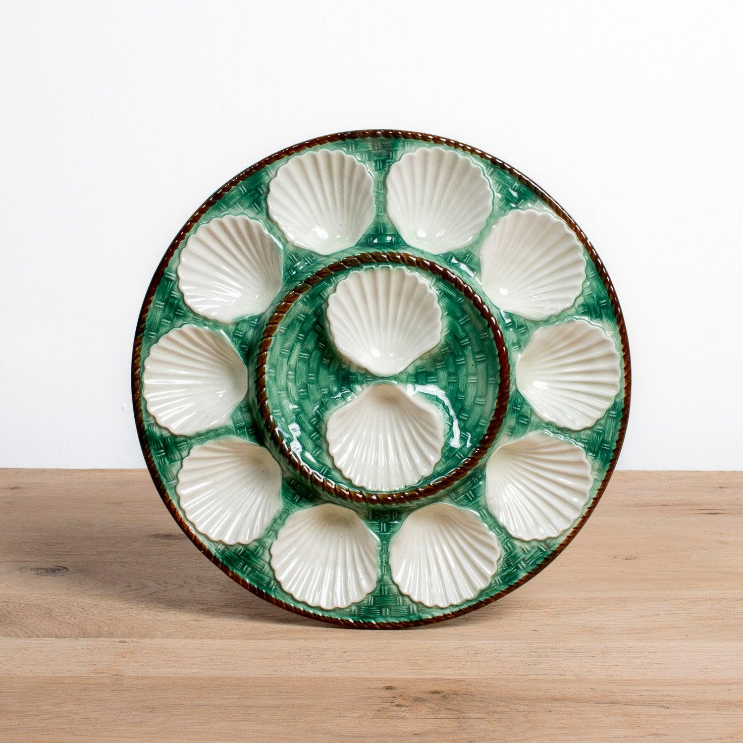 A stunning example of 19th century French craftsmanship, this majolica glazed oyster master server platter was produced by the renowned faïencerie of St. Clément, circa 1890s. Designed to both delight the eye and elevate the art of entertaining, the
