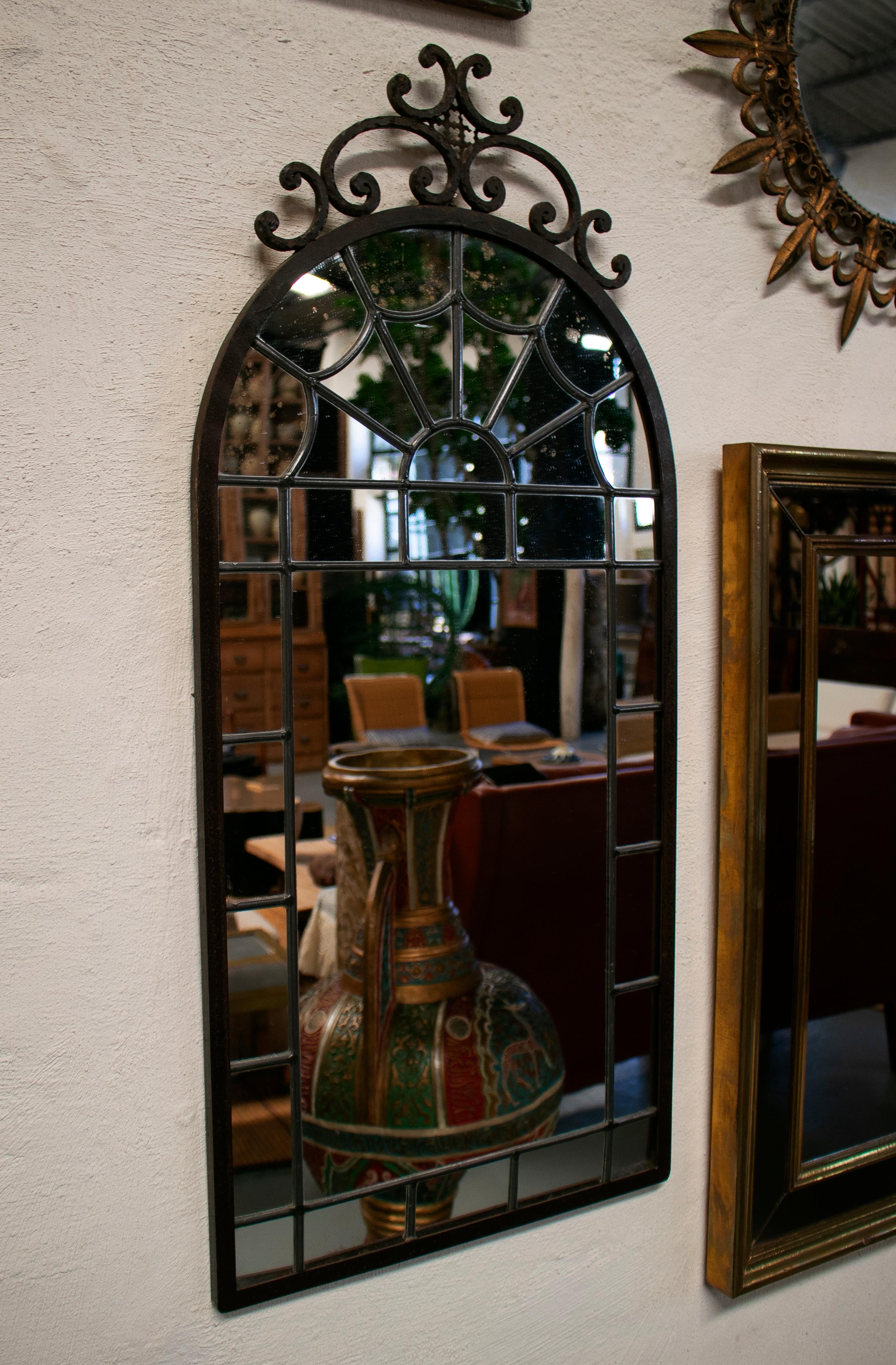 19th century French mirror in an iron frame with small pieces arranged to form patterns and held together with the traditional stained glass technique of using strips of lead.
  