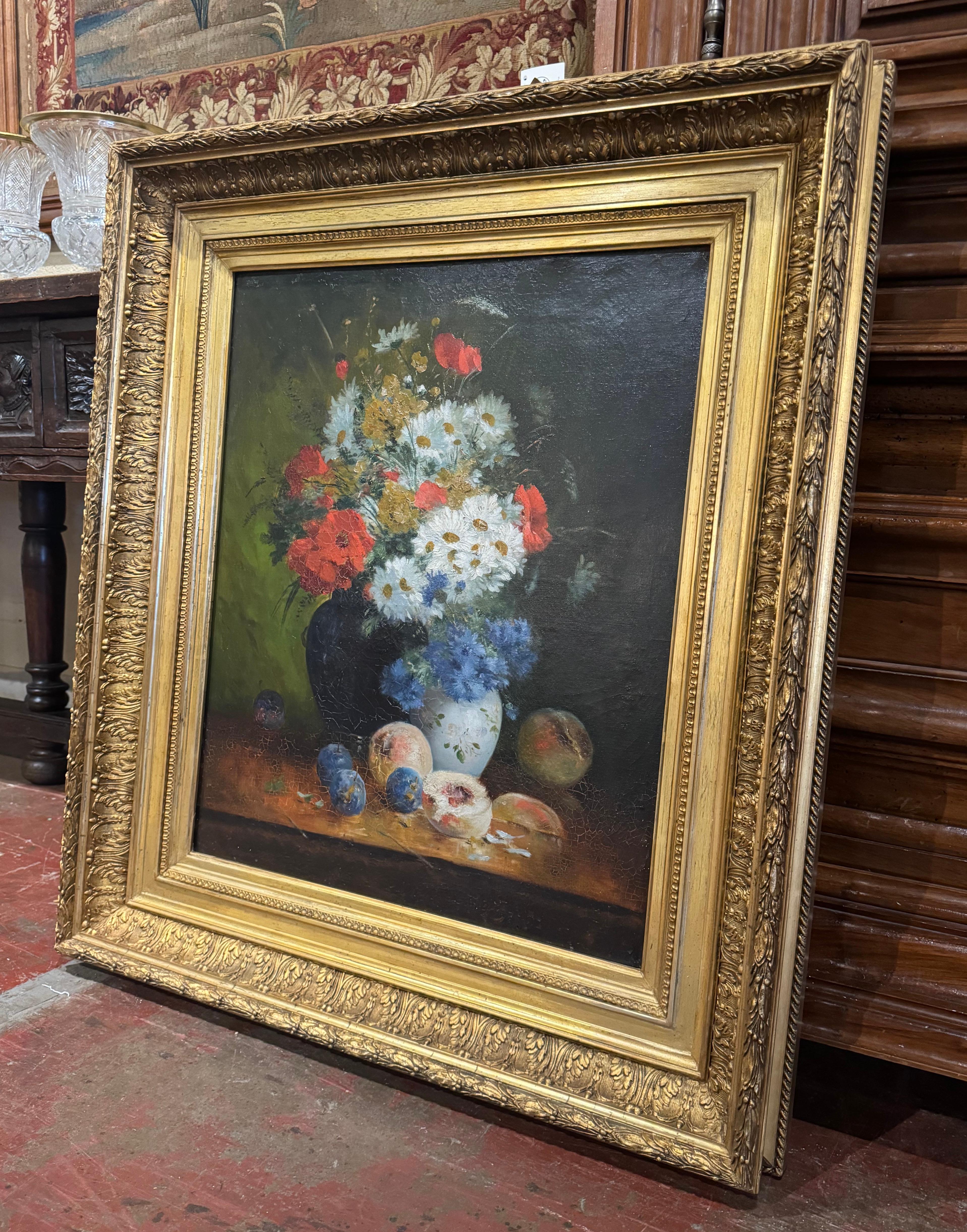 Invite colors to a wall with this elegant antique floral painting. Crafted in France circa 1850, and set in the original carved gilt frame, the colorful canvas depict a classic still life scene, featuring a vibrant bouquet of flowers arranged in a