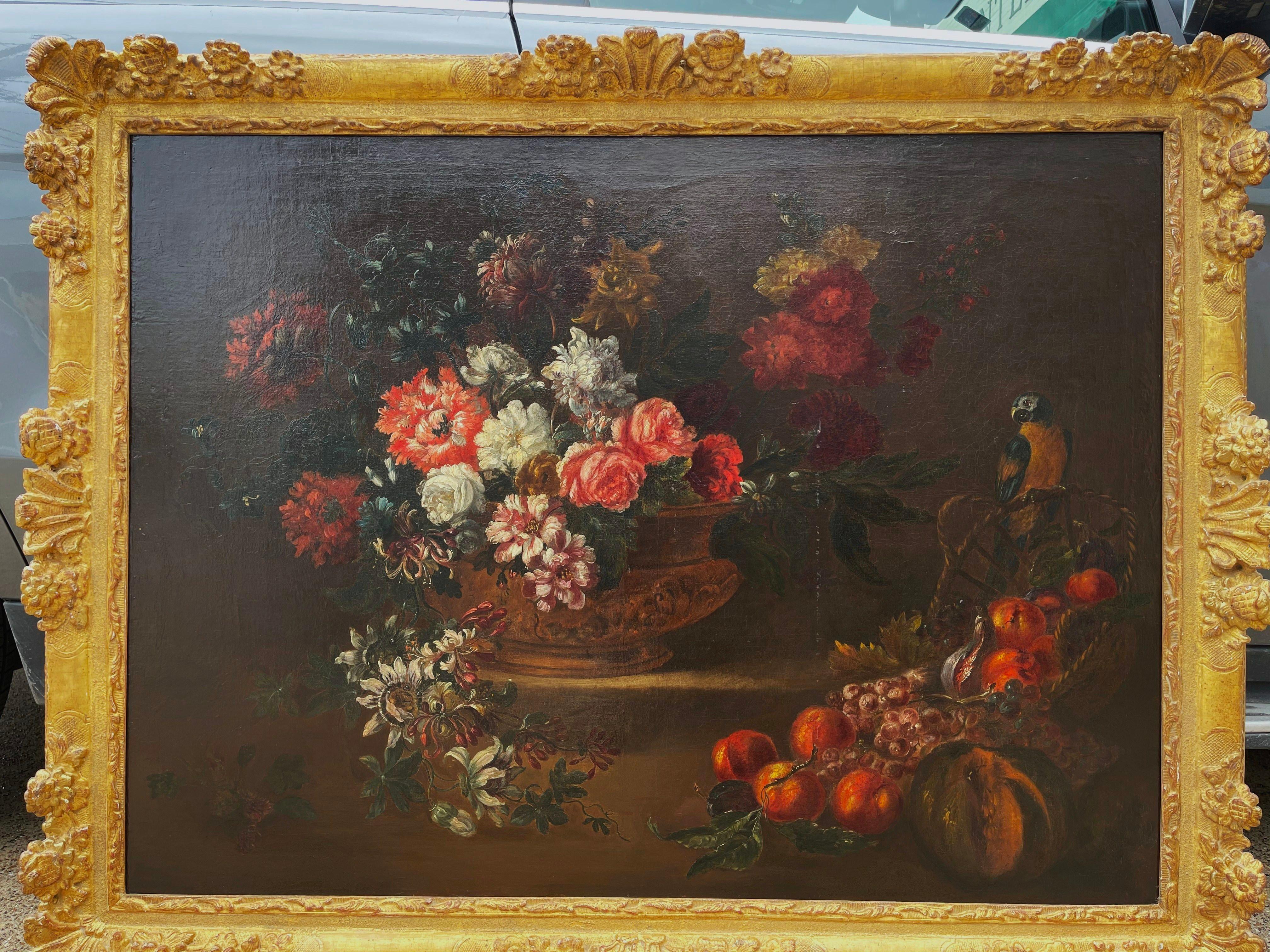 Invite color into your home with this important antique still life oil on canvas painting. Painted in France circa 1870 and set in the original carved gilt frame, the composition depicts a vase filled with colorful flowers, with fruit arrangement on