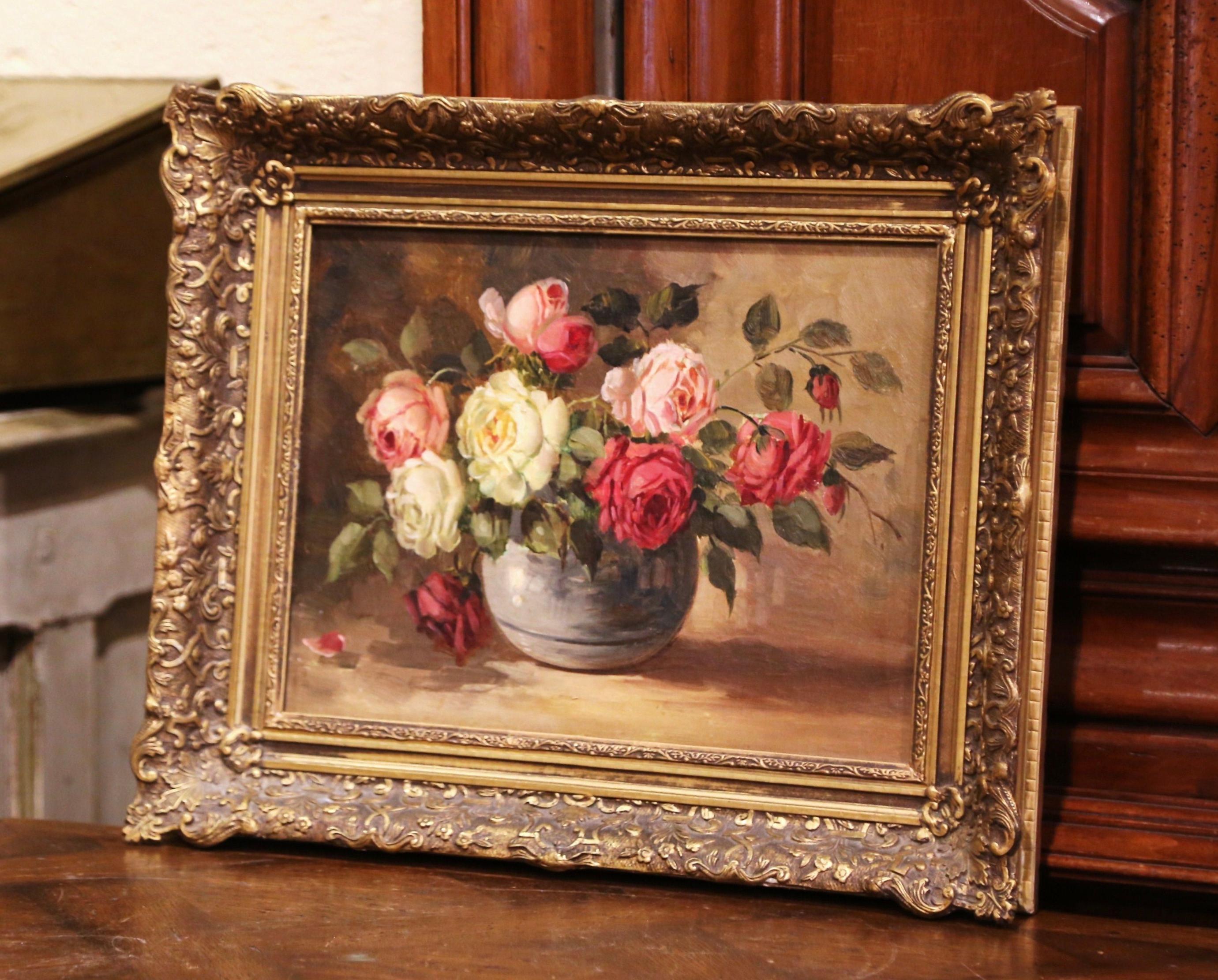 Hand painted in France circa 1880 and set in the original carved giltwood frame, the colorful art work depicts a still life scene with a terracotta cachepot filled with roses and foliage. The painting is in excellent condition with rich colors in