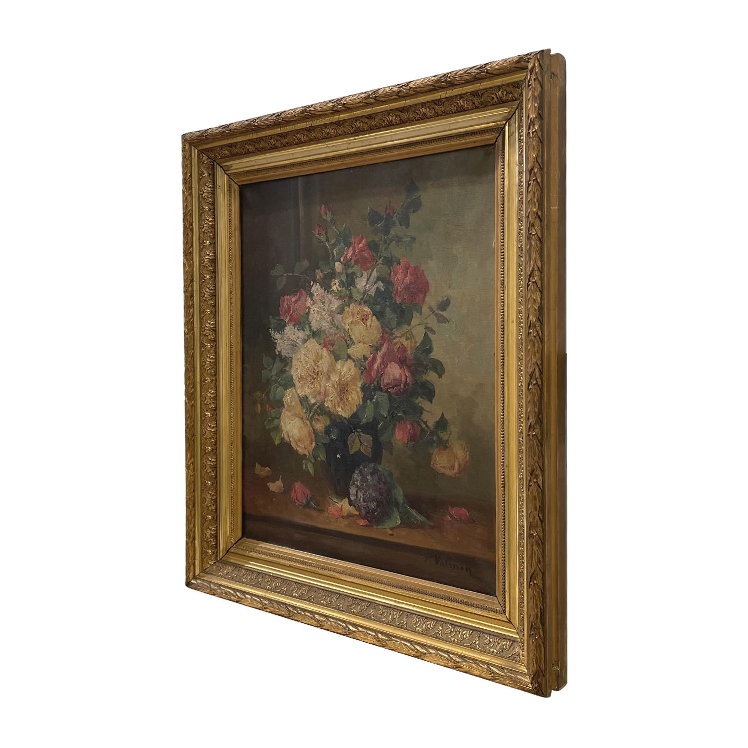 A red-yellow, antique French still life oil on canvas painting depicting a working table with a dark-blue vase with flowers, painted by Eugène Henri Cauchois in a hand carved, original gilded stucco wood frame, particularized by leafs, in good