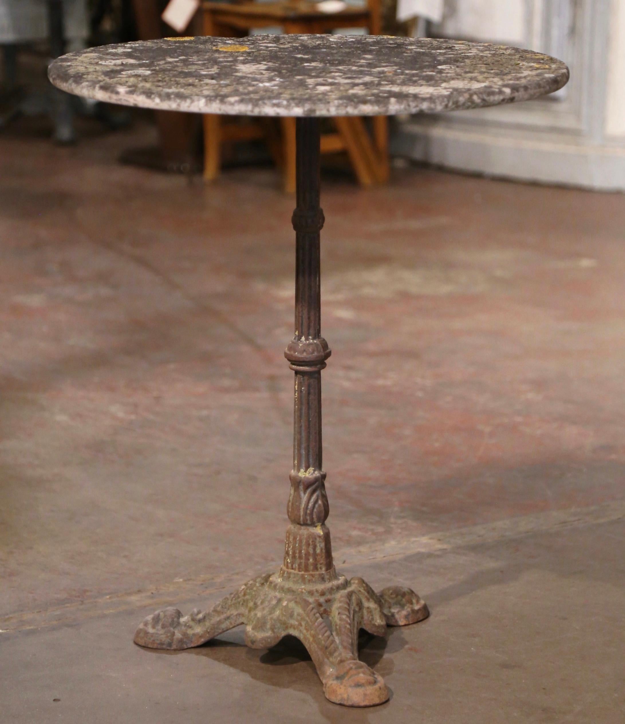 This exquisite, antique Napoleon III gueridon is as authentic and original as it can be! Crafted in Normandy, France, circa 1870, the classic bistrot table features a round stone top with all natural finish over a long iron stem ending with three