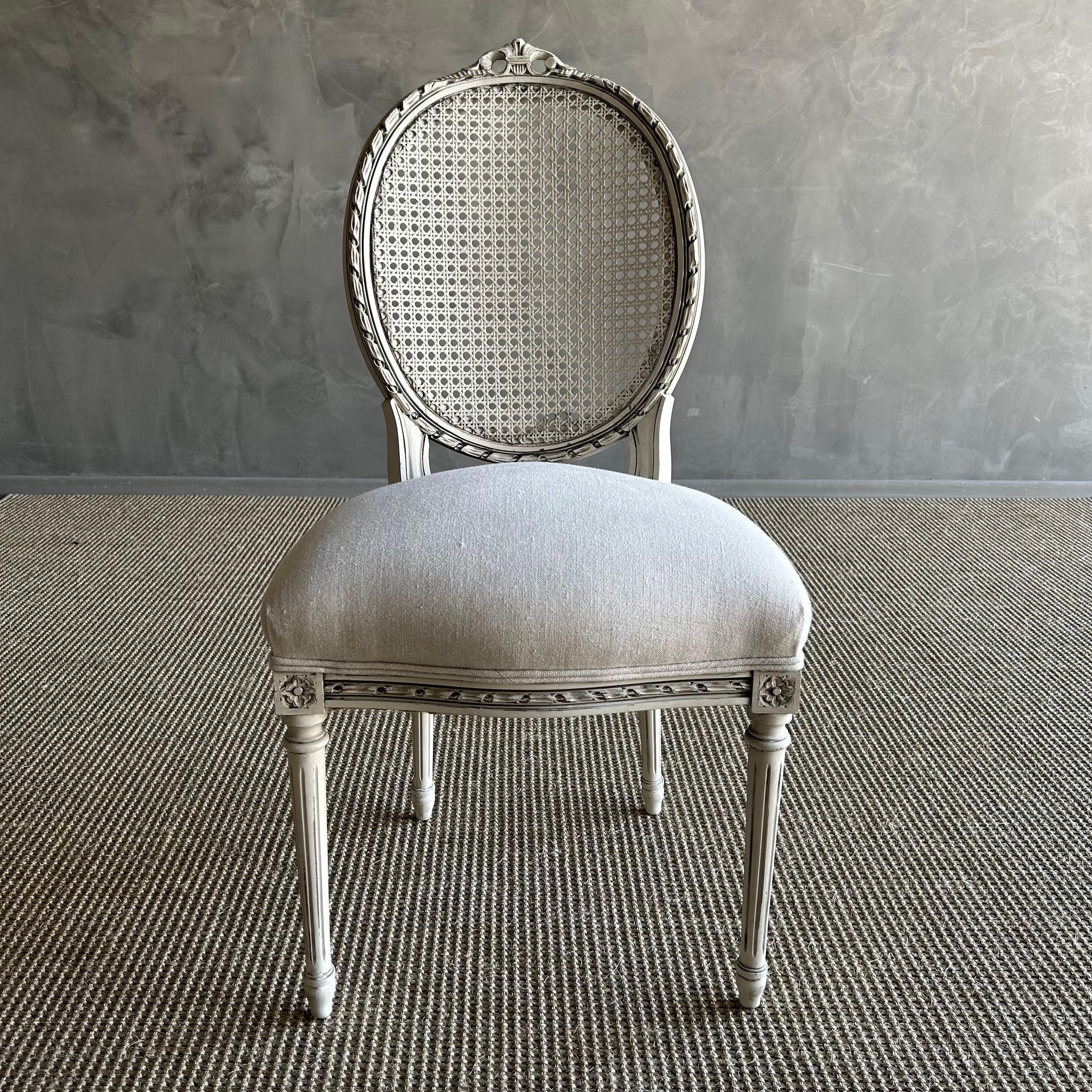 Exquisite 19th century French cane chair crafted from solid walnut and painted in a charming oyster white finish. This chair is not only visually stunning but also robust and dependable, perfect for daily use. Whether you are looking for a chic
