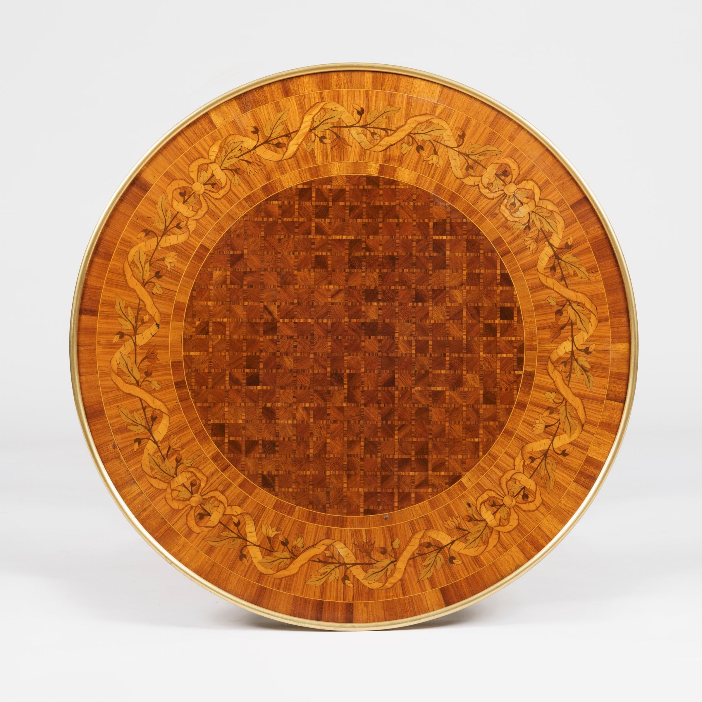 A fine Gueridon after Adam Weisweiler
Firmly attributed to Francois Linke
 
Constructed in mahogany and kingwood, with marquetry and parquetry inlays, adorned with bronze mounts; of circular form, rising from four sets of faux bamboo paired