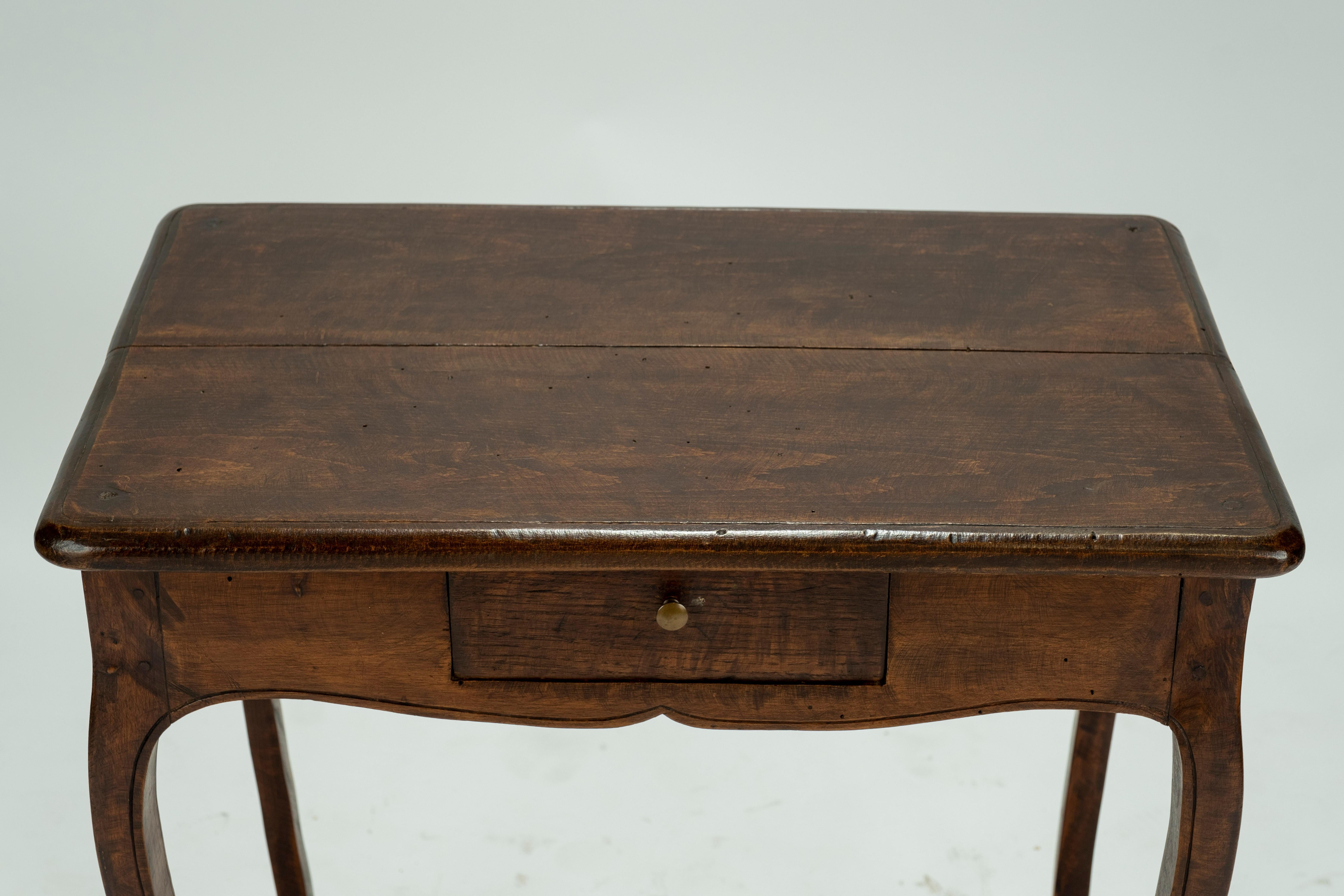 Louis XV walnut table with cabriole legs and a small drawer.