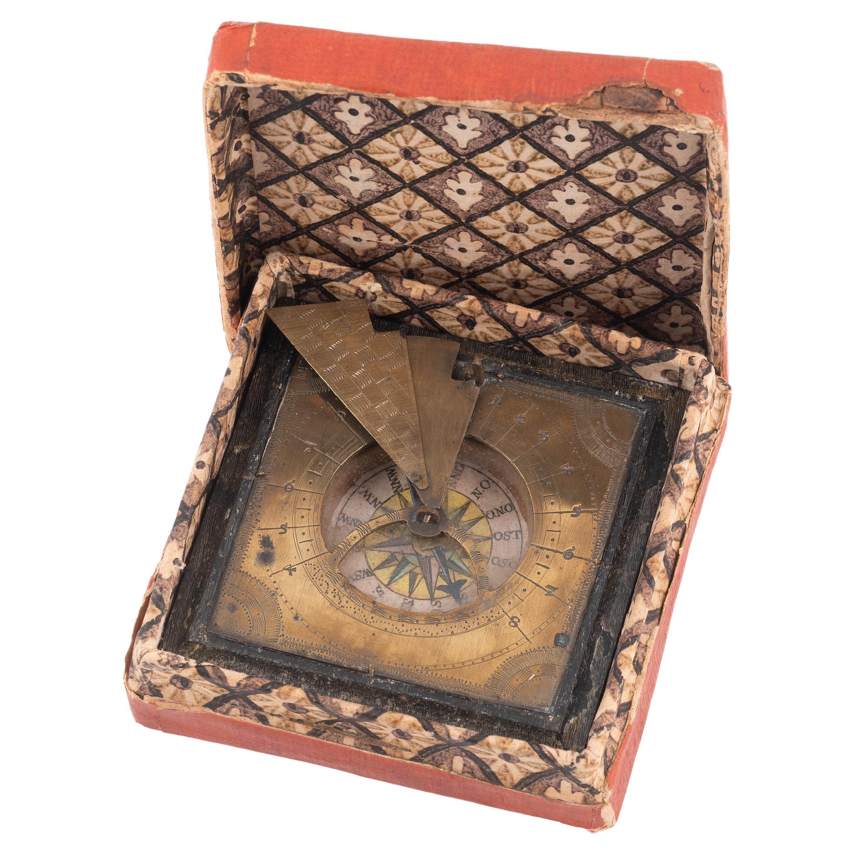 Shipping policy
No additional costs will be added to this order.
Shipping costs will be totally covered by the seller (customs duties included). 

Brass sundial with folding gnoman. Wood painted base holds a needle compass over paper dial. Circa