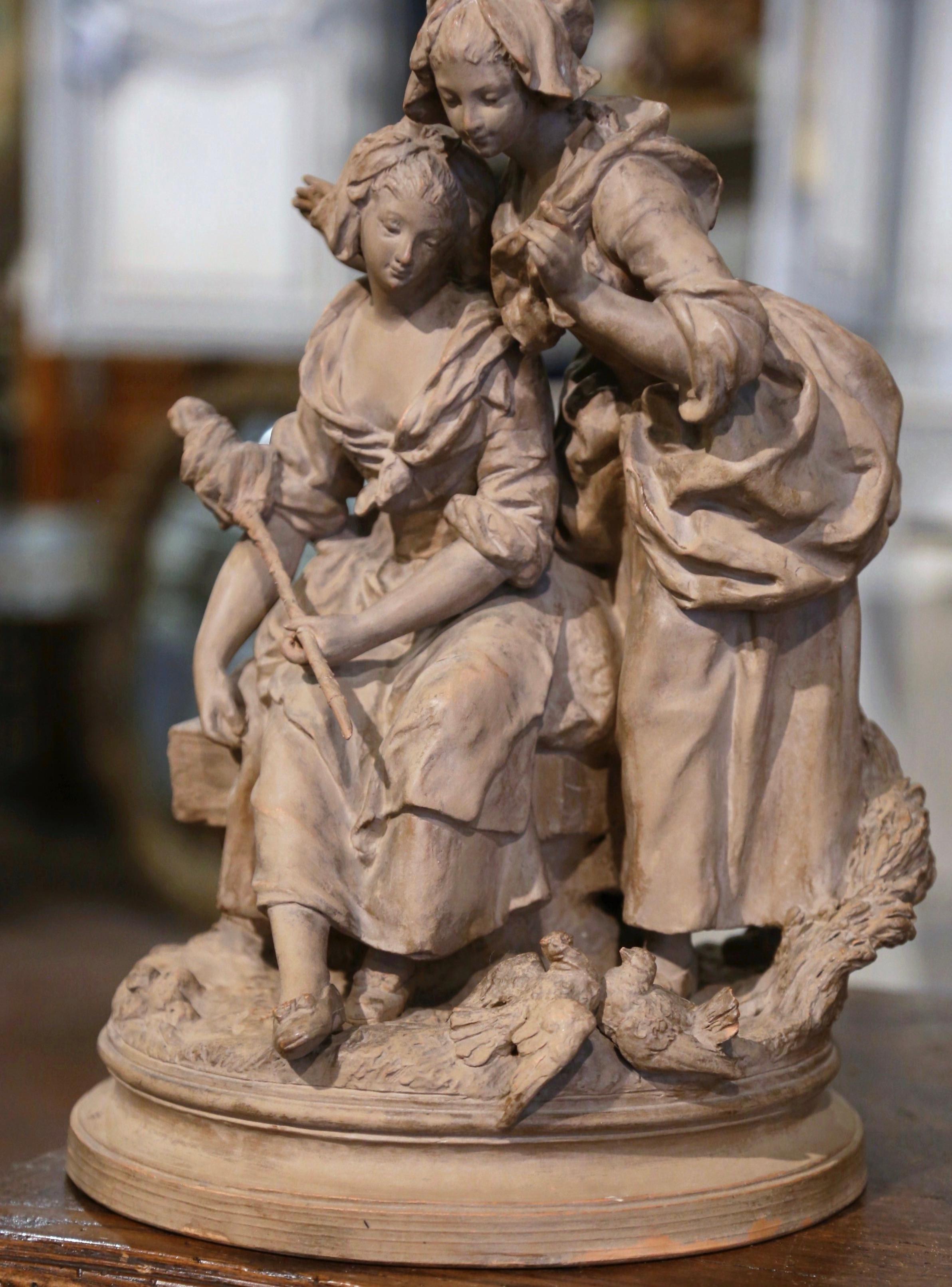 Decorate a lady's office with this elegant antique figure. Sculpted in France, circa 1870, the terracotta composition depicts two young female beauties looking at two love birds. Wonderful details throughout. The sculpture is in excellent condition