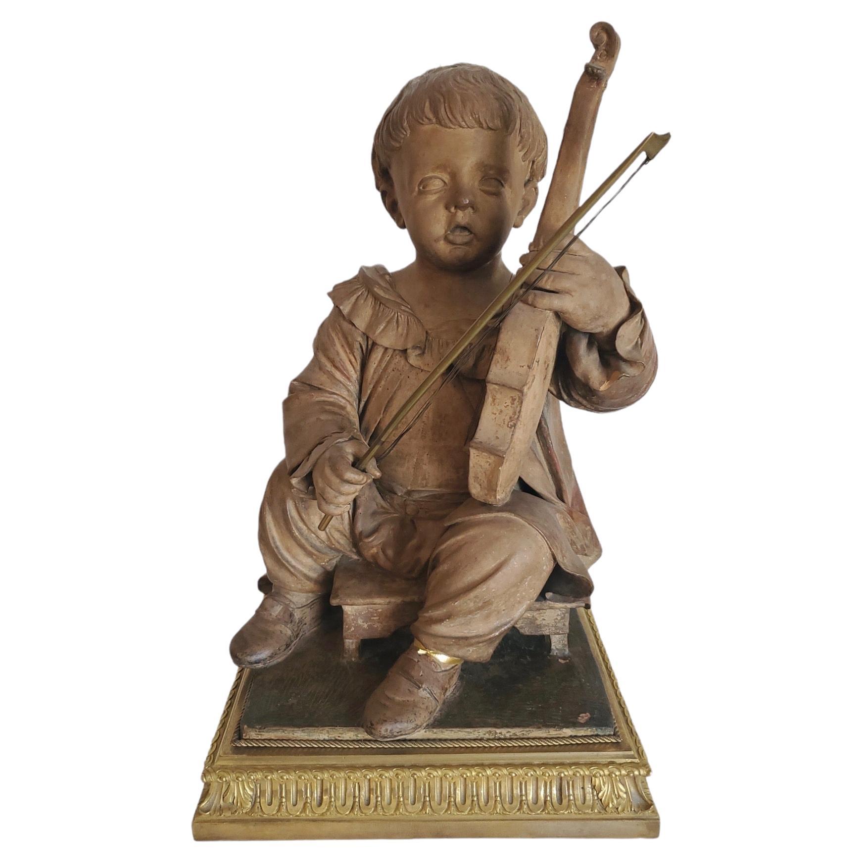Statue de garçon en terre cuite française du 19e siècle