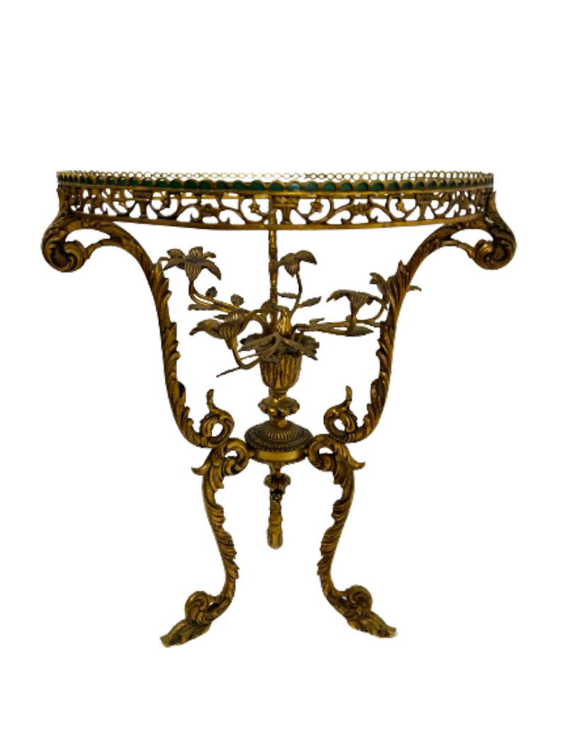 19th Century French three legged bronze side table 

19th Century French small three legged bronze side table. The legs with scrolled leaf motif and at the top in the middle a rosette of 6 arms branch with leaves with flowers. Glass on top, raised