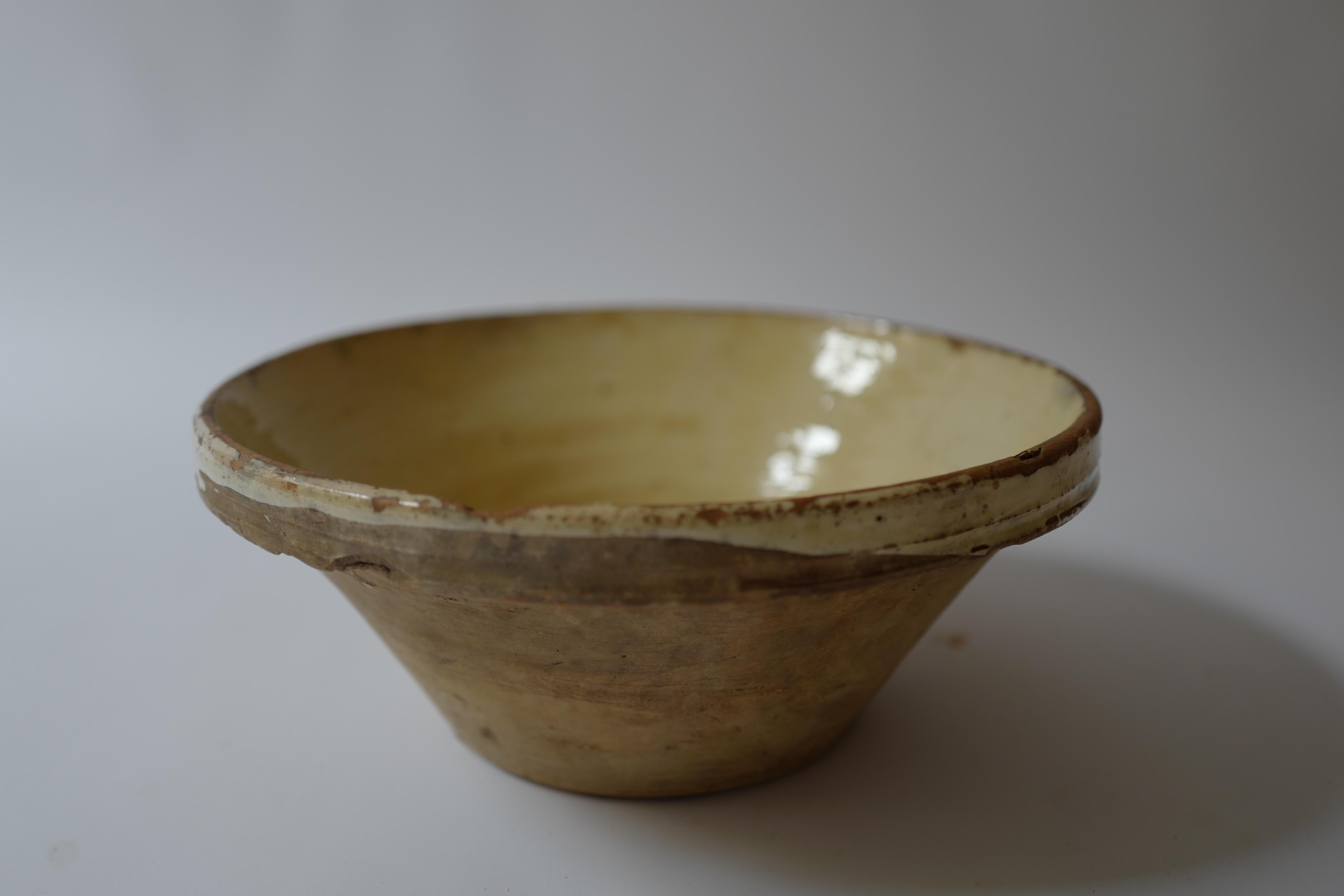 A 19th century French terracotta tian bowl with a lovely yellow glaze. Circa 19th century found in Provence, France. These were used for preparation as mixing bowls made of earthenware. The tian style bowl is originally from Narbonne, France near