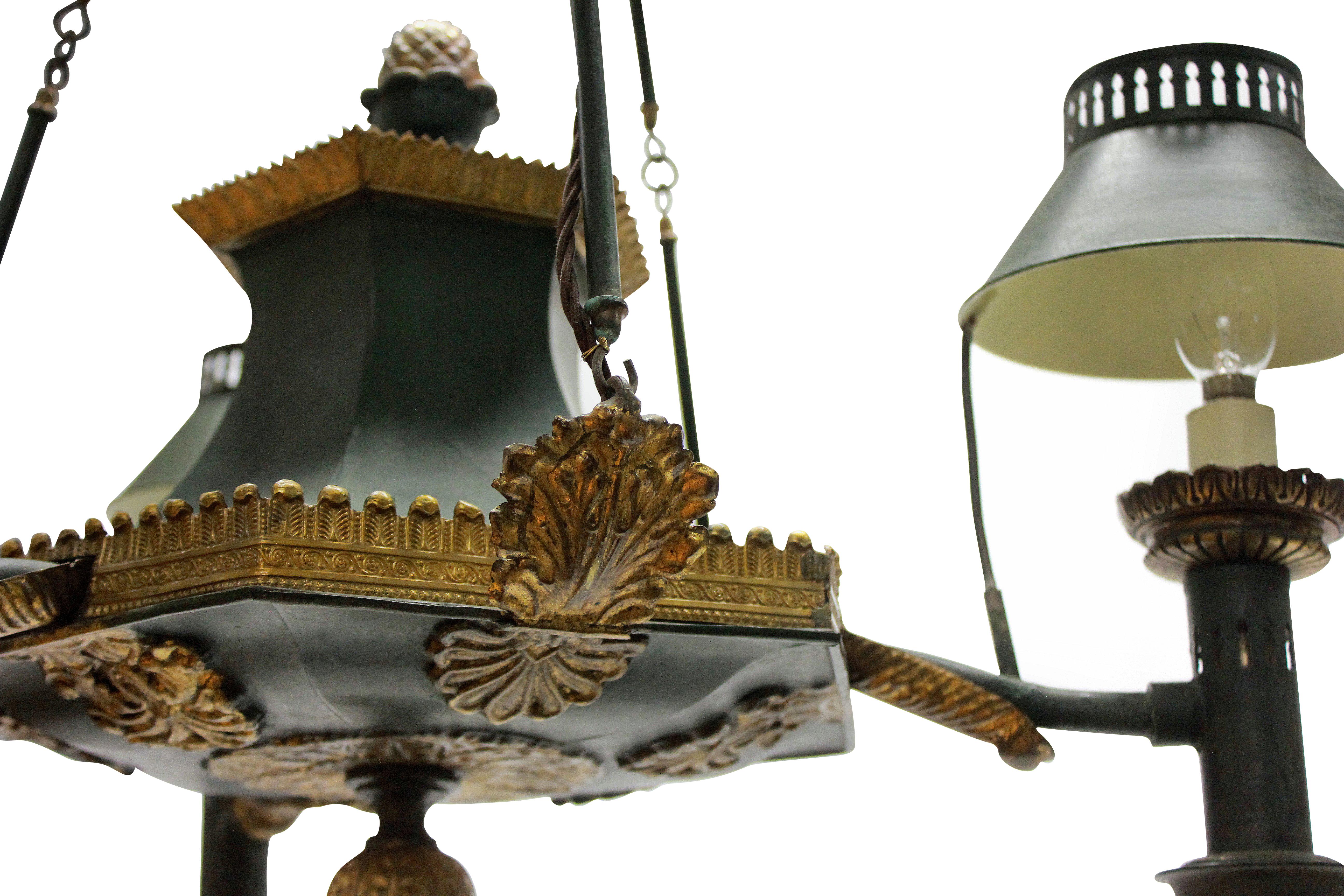 A French 19th century toleware chandelier in dark green paint with gilt brass detailing. Formerly for oil, now electrified.