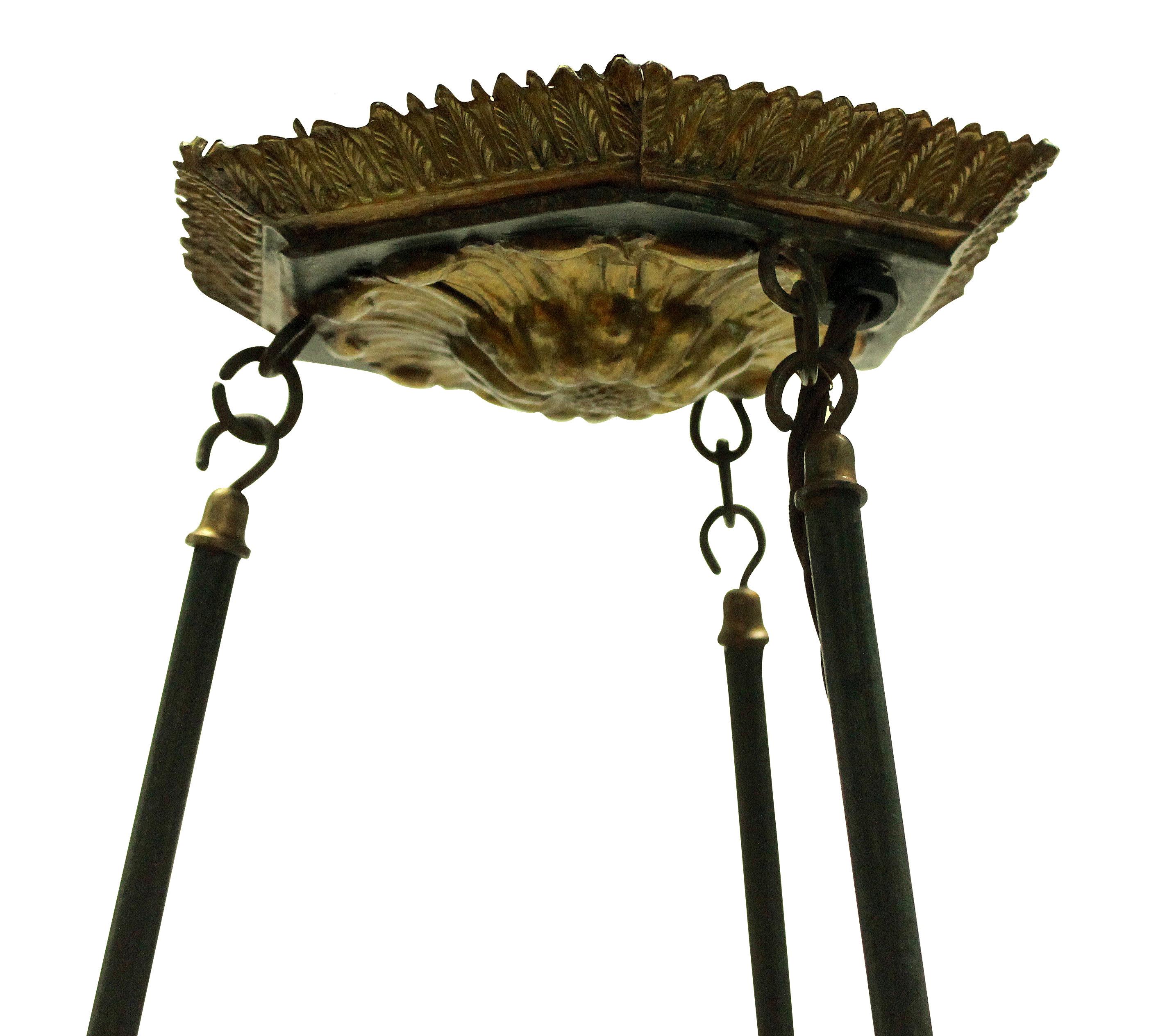 A French 19th century toleware chandelier in dark green paint with gilt brass detailing. Formerly for oil, now electrified.