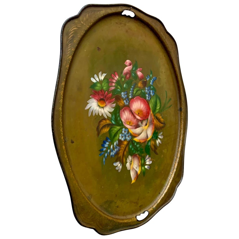 French hand painted toleware tray of the Napoleon the III era, circa 1850's. The hand-painted French metal tray is decorated with flowers and leaves on a green background with gold painted decorations. This beautiful antique tray can be used as a