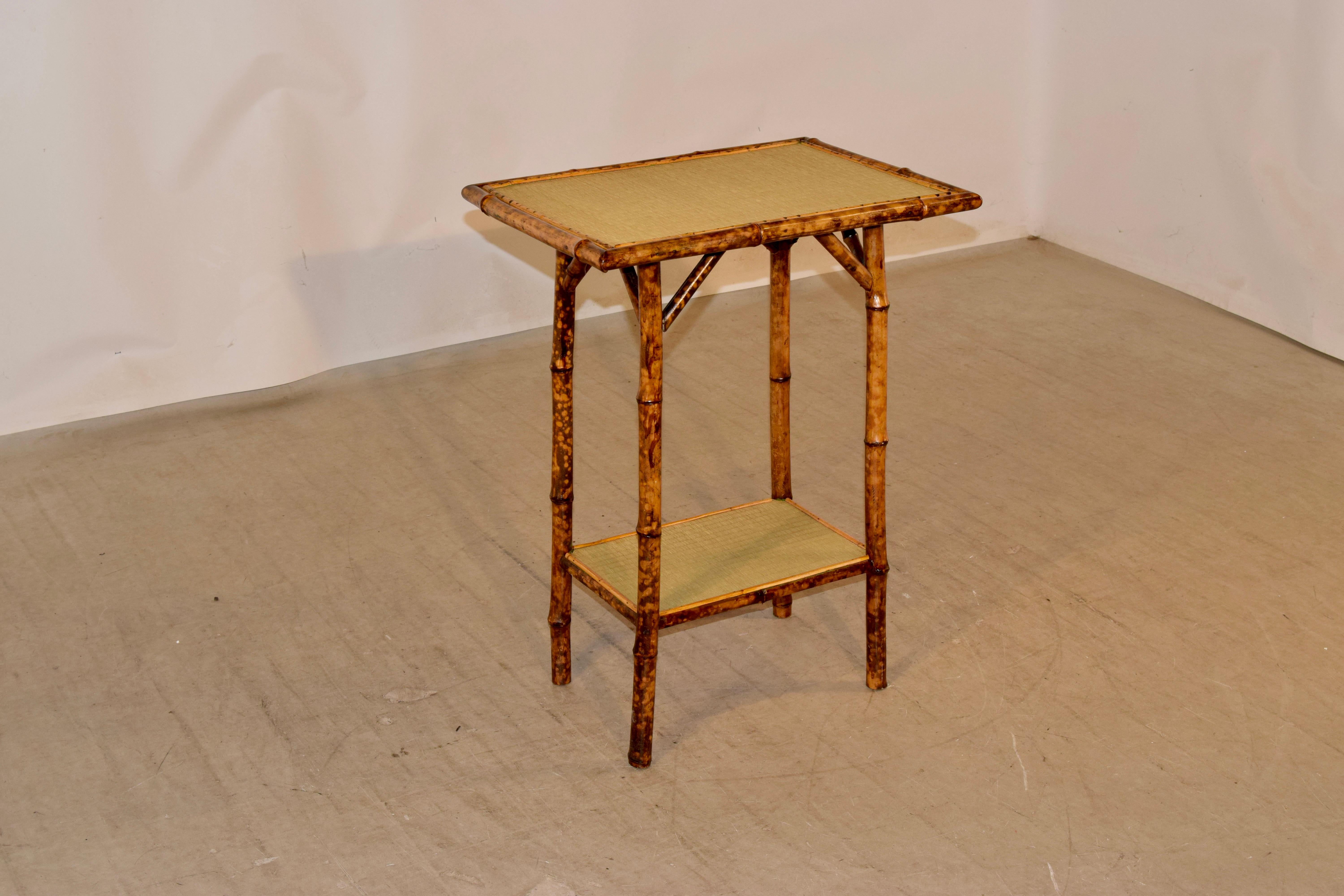 19th century tortoise bamboo side table with rush covered top and lower shelf.