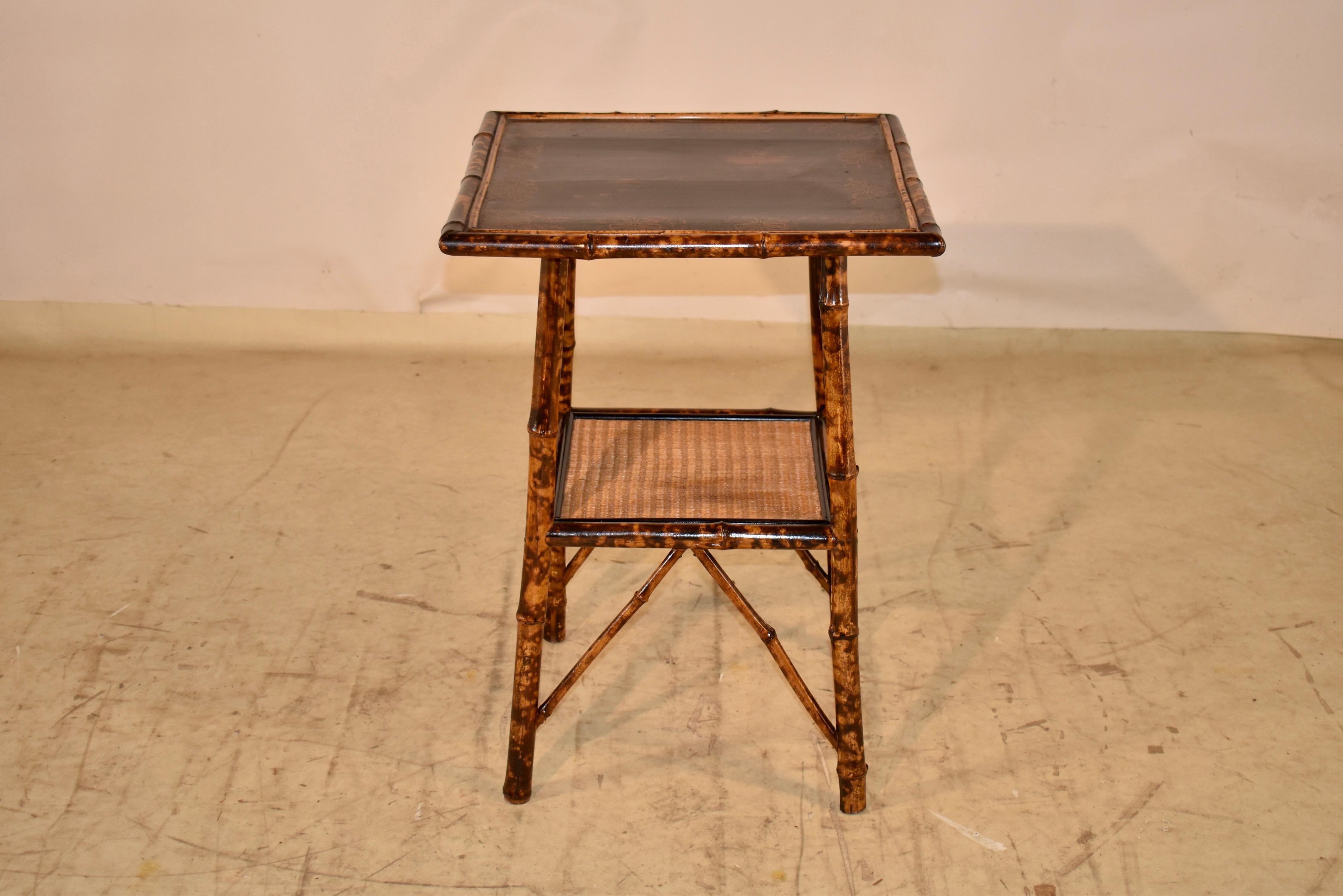 19th century tortoise bamboo side table from France.  The top is hand painted lacquer, and has normal wear and scratching to surface for age and use.  The frame of the table is made from tortoise bamboo and the legs are slightly splayed for added