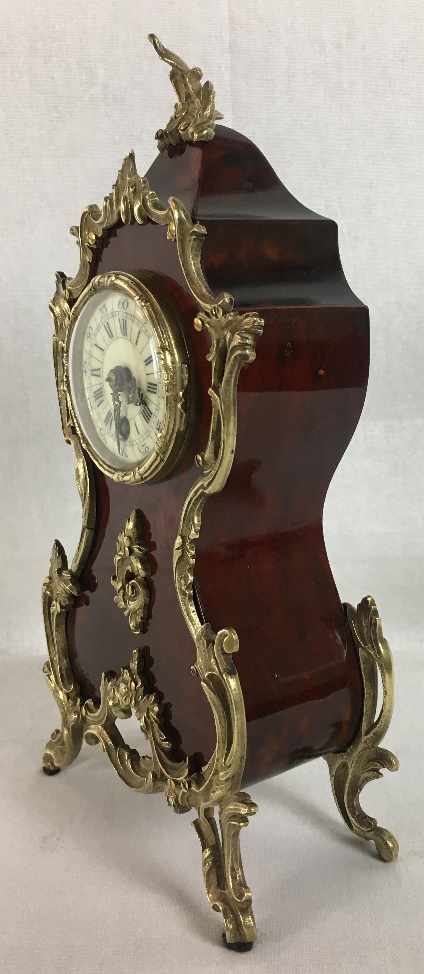 A superb quality antique French clock, circa 1875. This Boulle style mantel clock is made with red tortoiseshell typical of the period, and brass inlays to the case front and sides further accentuates the beauty and high quality craftsmanship.