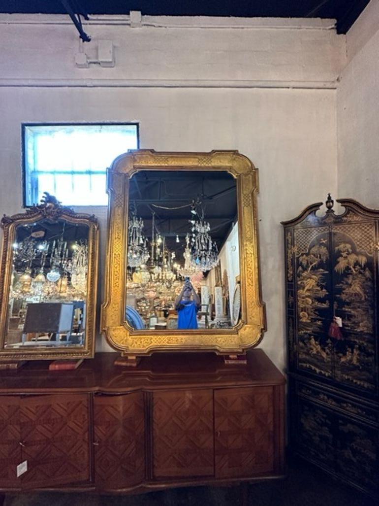 Beautiful 19th century large French transitional giltwood mirror. Lovely scalloped edges and a gorgeous decorative pattern. Superb!