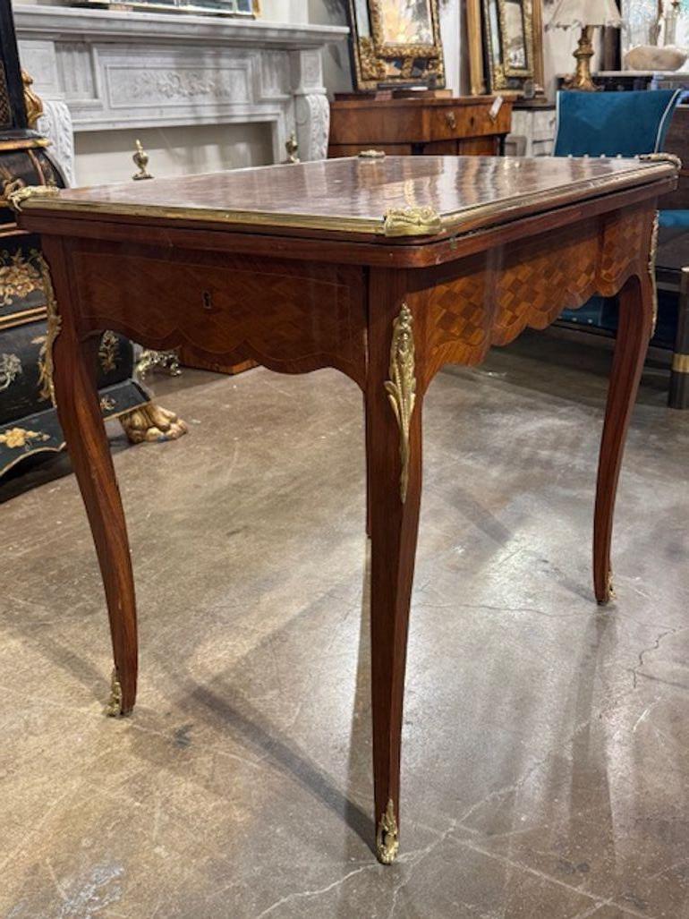 This product is a rare and elegant 19th century French transitional game table made of kingwood and mahogany.  The inlaid design gives it a unique and classic look, making it a stunning piece of furniture that can serve both practical and decorative