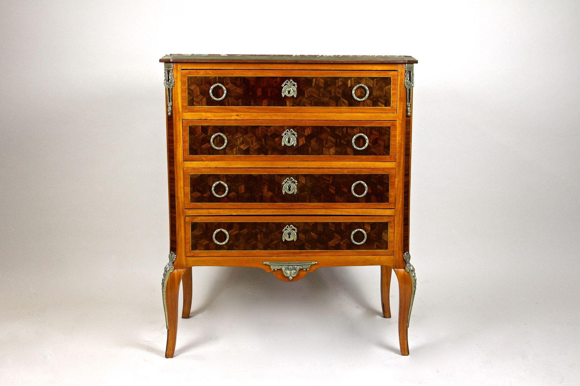 Outstanding 19th century French marquetry chest of drawers from the period around 1870. Providing four lockable drawers, this absolute eye-catching dresser was made of fine cherrywood and impresses with its elaborately set marquetry work on the