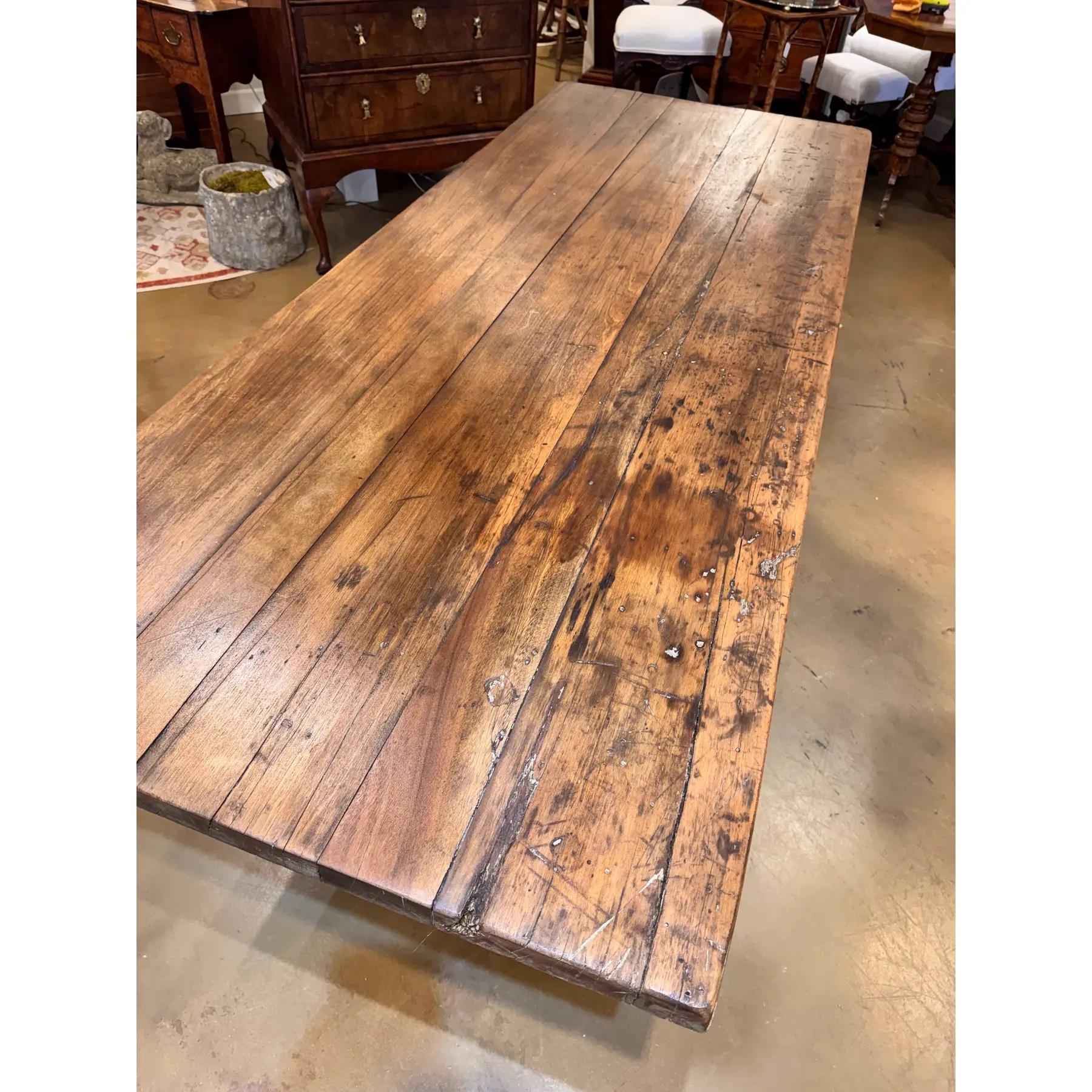 This is a beautiful early 19th century French table! The wood has a soft tan natural tone, with lovely natural detail visible along the top and sides. This piece is set on a trestle base which is very sturdy and heavy as well. This would be a great