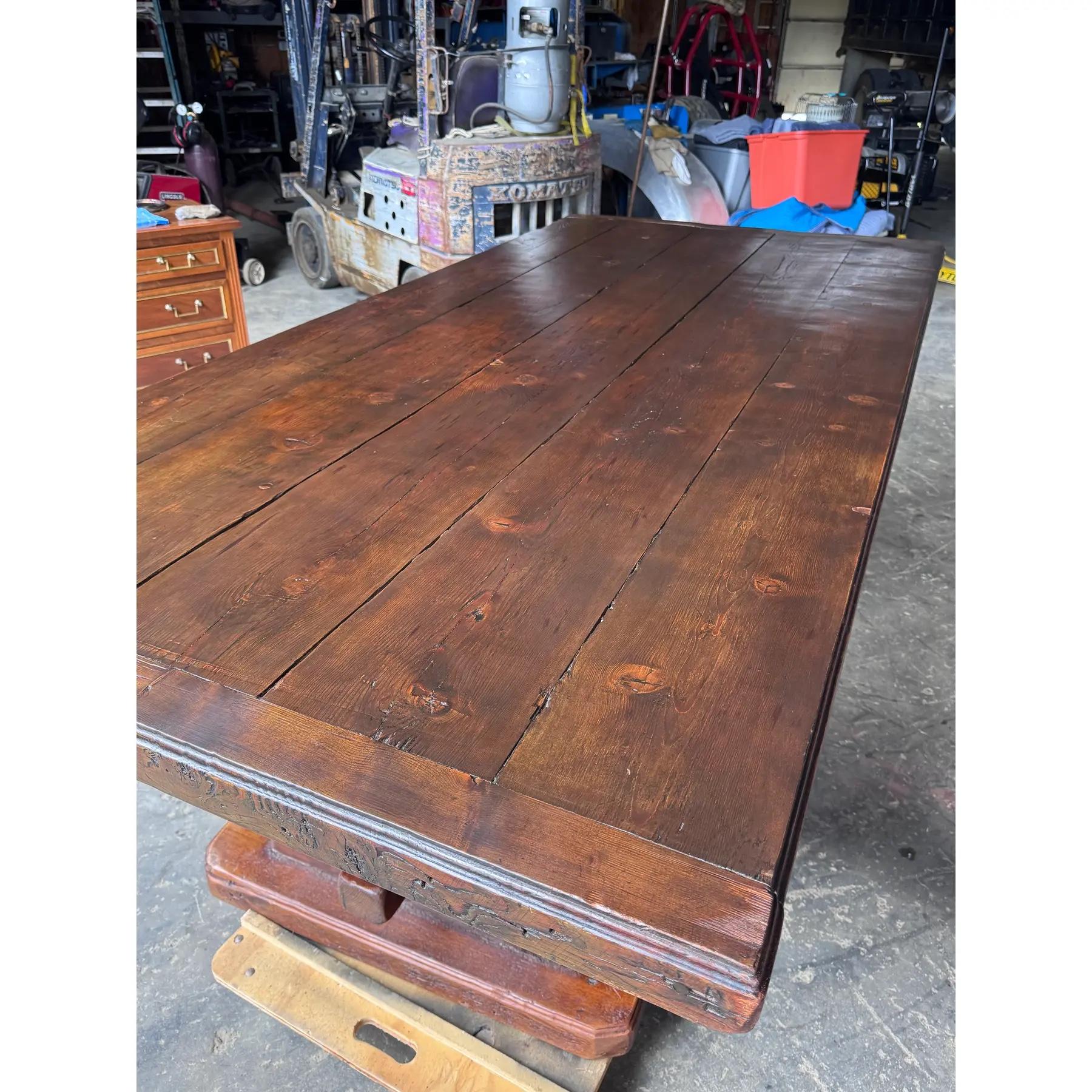 This is a 19th century English trestle table the width of 44' makes it very unusual. This is a chunky table with a thick top the wood is pine with beautiful age and patina the shape of the base allows for seating all the way to the end. This is a