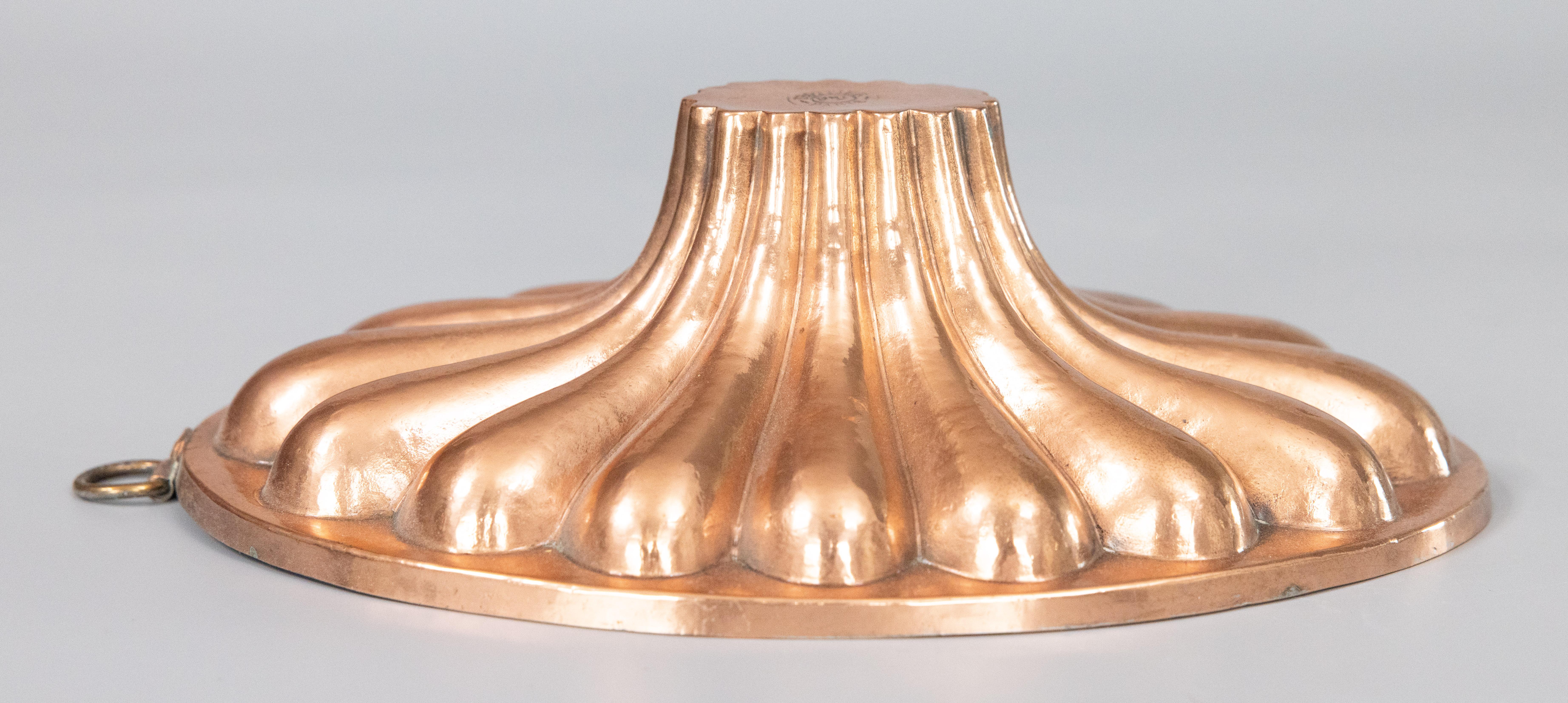 A lovely antique 19th-Century French oval gadrooned copper culinary baking mold with tin lining, signed Trottier Paris, circa 1880. Trottier was one of the leading manufacturers of copper in France in the nineteenth century, known for making the