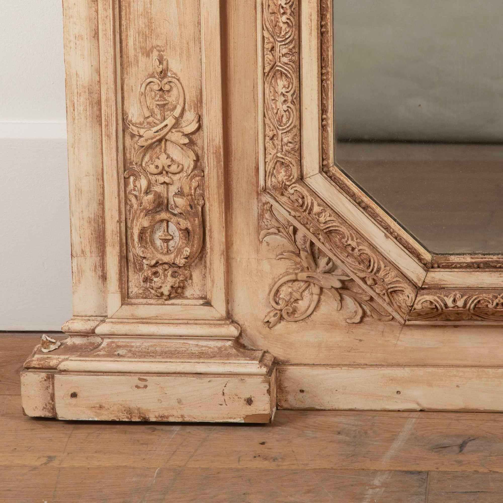 Beautiful late 19th Century French Trumeau mirror made from wood and gesso.
With lovely details around the frame including a pair of face masks at the top. The frame has nice worn paint giving it a beautiful appearance.
It also has it's original