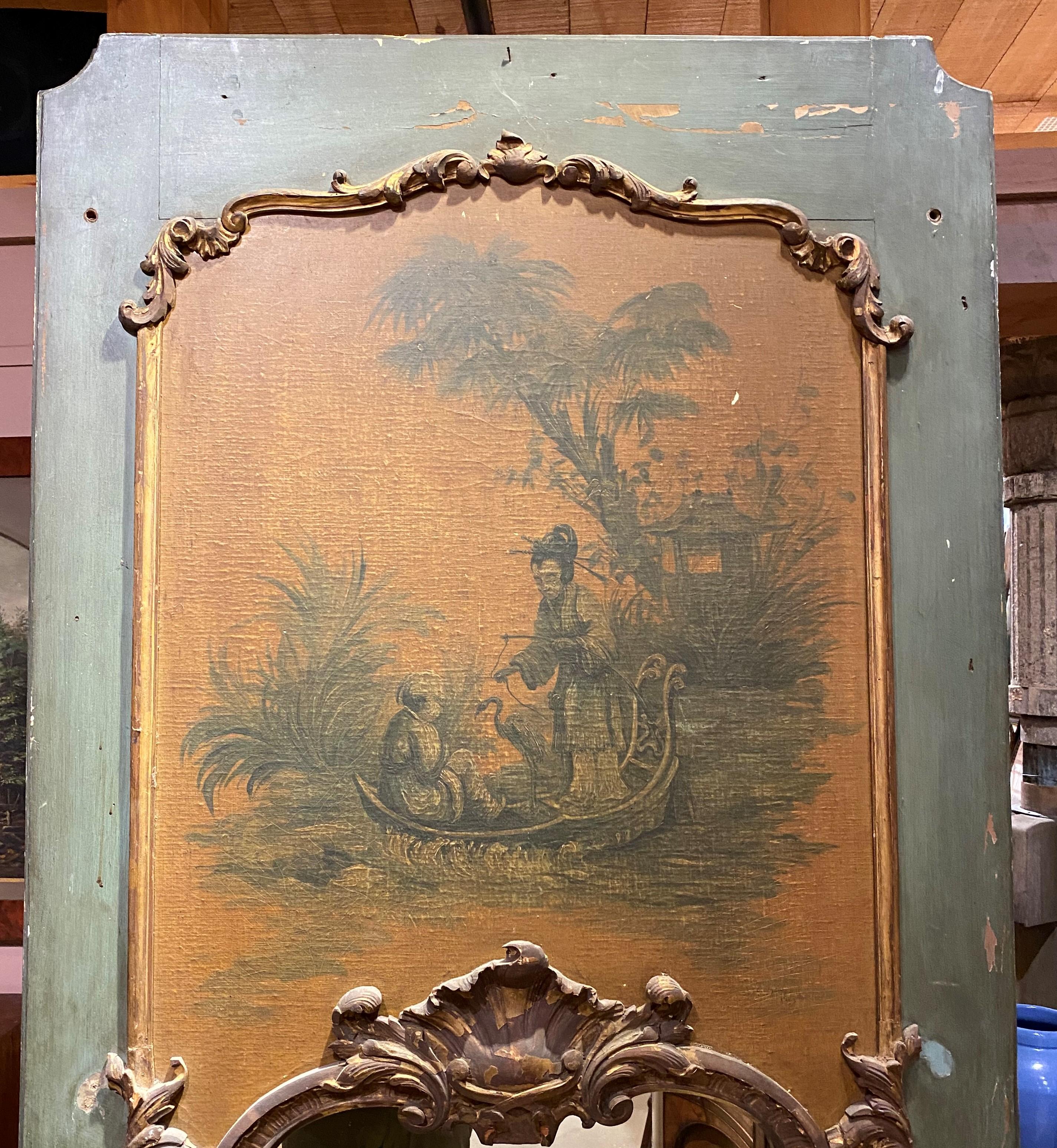 A beautiful French style trumeau mirror with gilt Rococo scroll carving, its upper chinoiserie panel painted with figures in a boat, all with a muted green panel surround. Dates to the 19th century in very good overall condition, with overall gilt