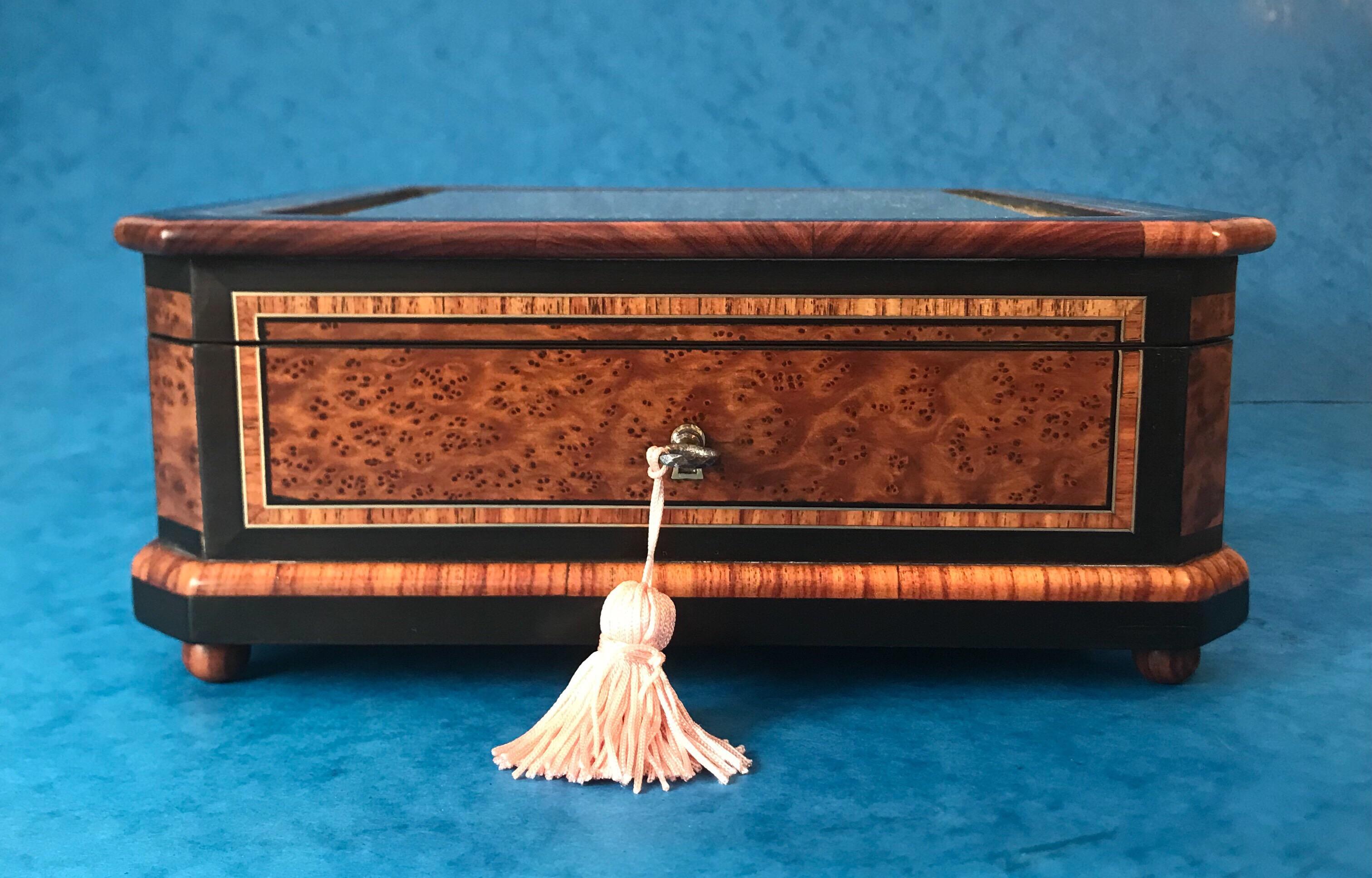 19th century French tulipwood crossbanded, burr cedar jewelry display box. The jewelry box dates back to 1870, it’s edged in ebony, crossbanded in Tulipwood and inlaid in brass with a mother of pearl pattern. The box has burr cedar panels either