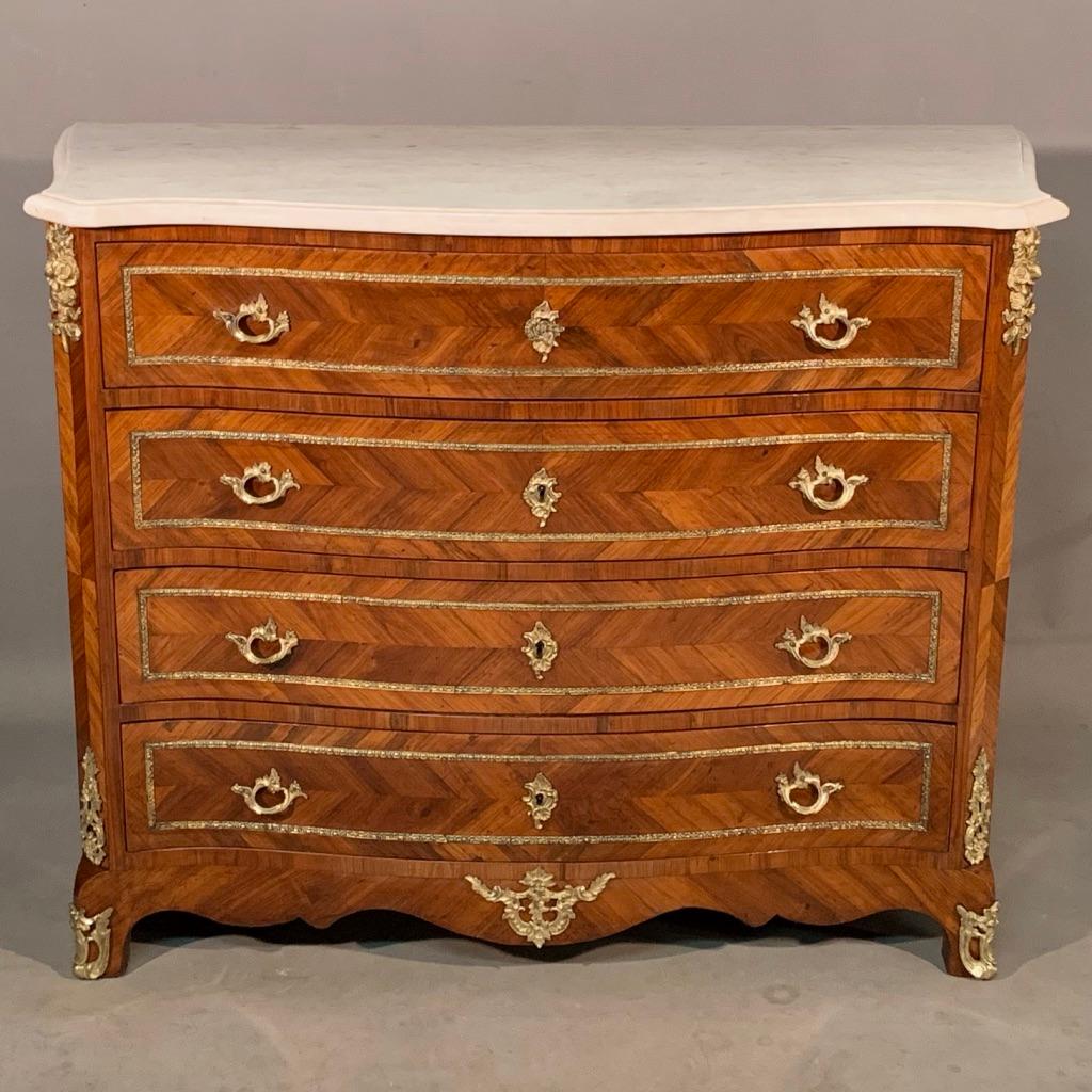 This is an extremely good quality and beautifully made French tulip wood Louis XV style commode with all original brass work and Carrara marble top.
The chest has been fully restored and has come up really very well, a full clean throughout, all