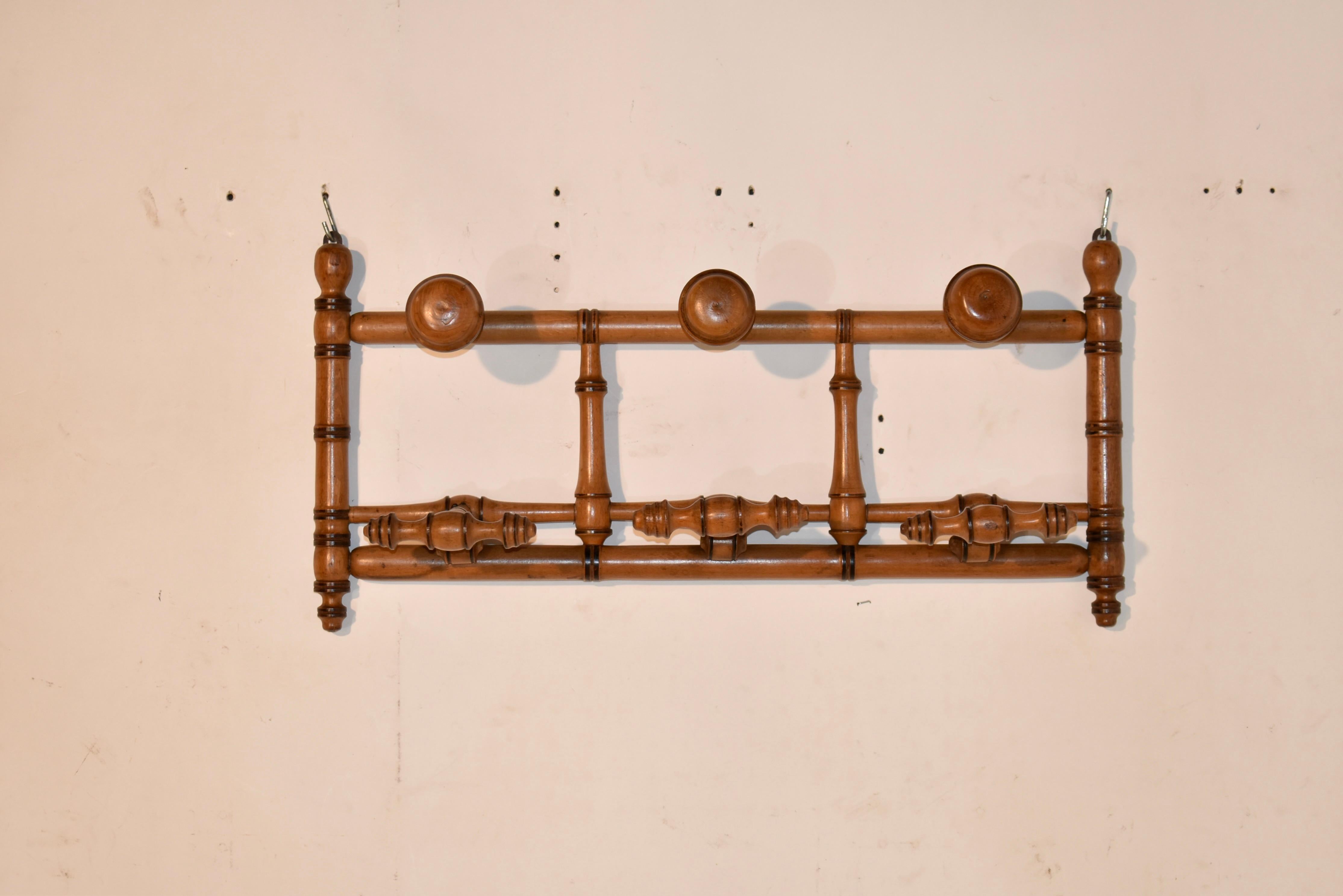 19th century cherry hanging wall coat and hat rack from France.  The lollipop knobs at the top are for hats, and the lower hangers pull down from a flat position to accommodate coats, or more hats, dog leashes, etc.  This is so versatile - it could