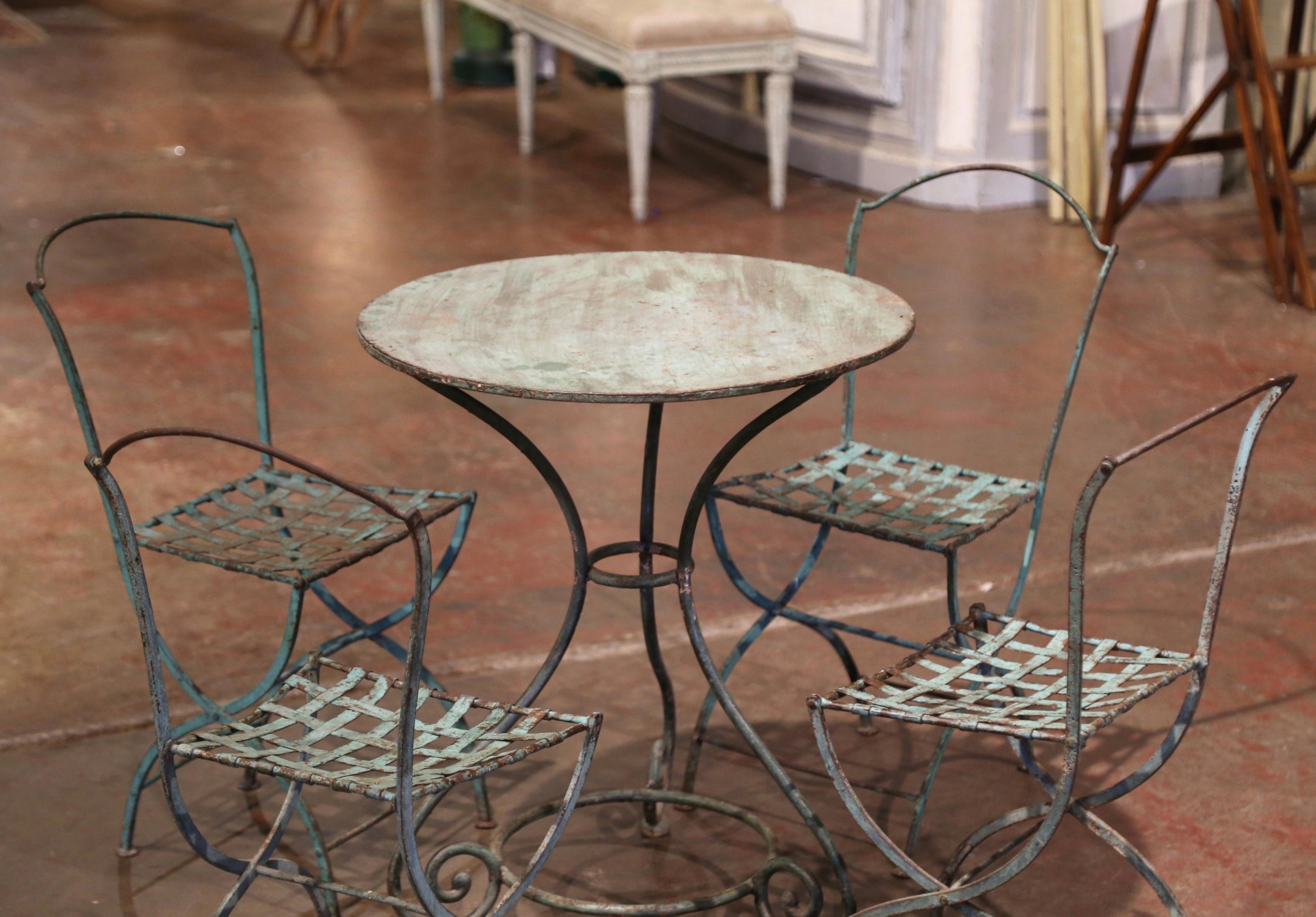 Decorate a backyard or a patio with this elegant antique bistrot set. Crafted in France circa 1880, the Napoleon III set includes a round pedestal table standing on three curved legs decorated with a circular bottom stretcher, and four matching