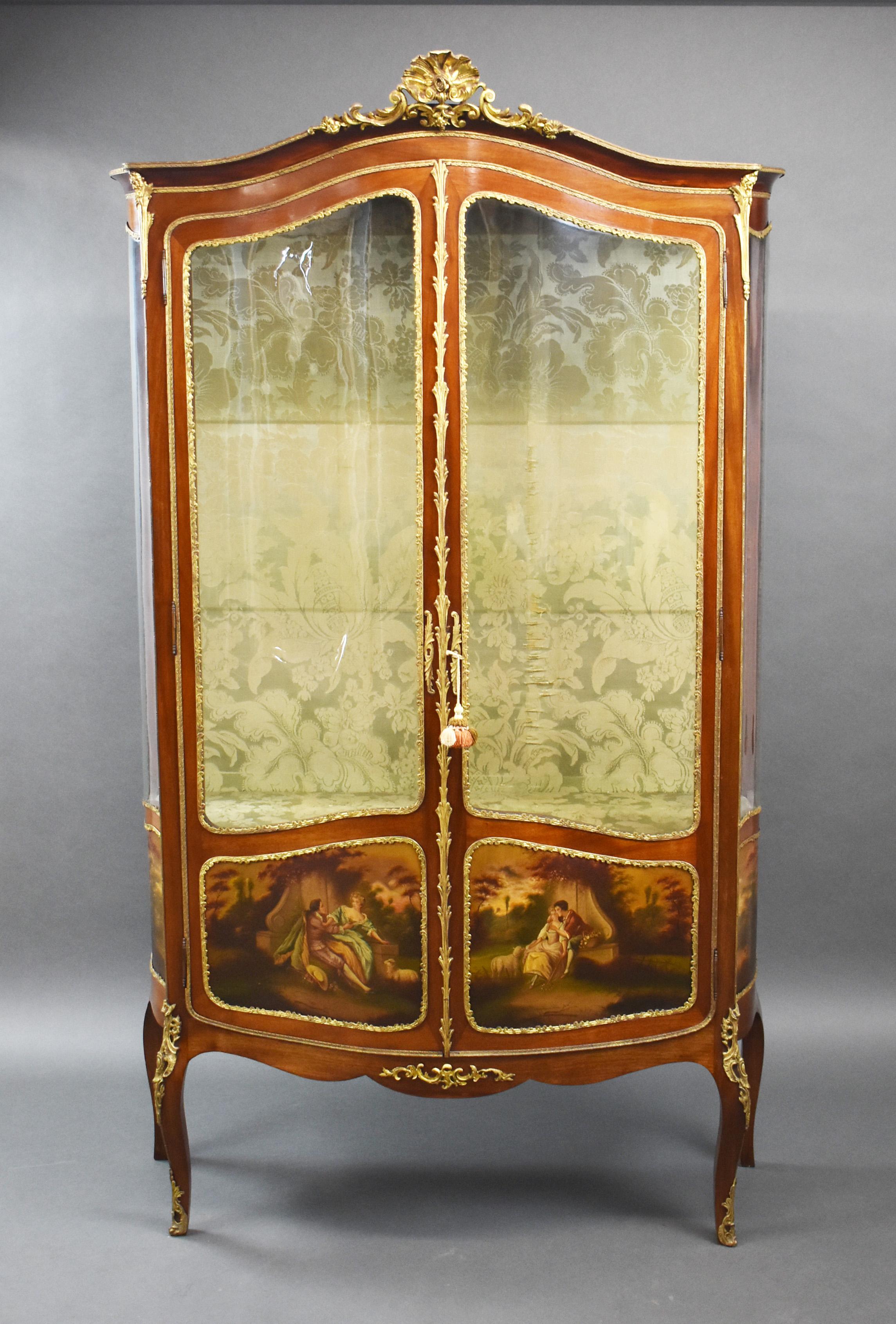 For sale is a good quality 19th century French Vernis Martin serpentine display cabinet. Having an ornate ormulu shell motif to the top, above two glazed doors, enclosing two glass shelves. Below this, each door has two finely painted panels, with a
