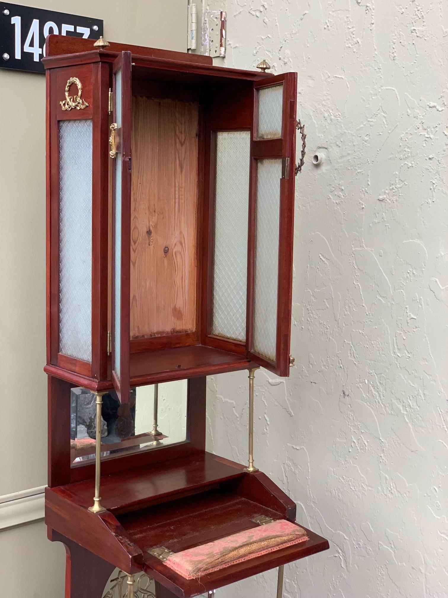 The Prie-Dieu is a type of prayer desk primarily intended for private devotional use, but may also be found in churches. It is a small, ornamental wooden desk furnished with a thin, sloping shelf for books or hands, and a kneeler. Sometimes, instead