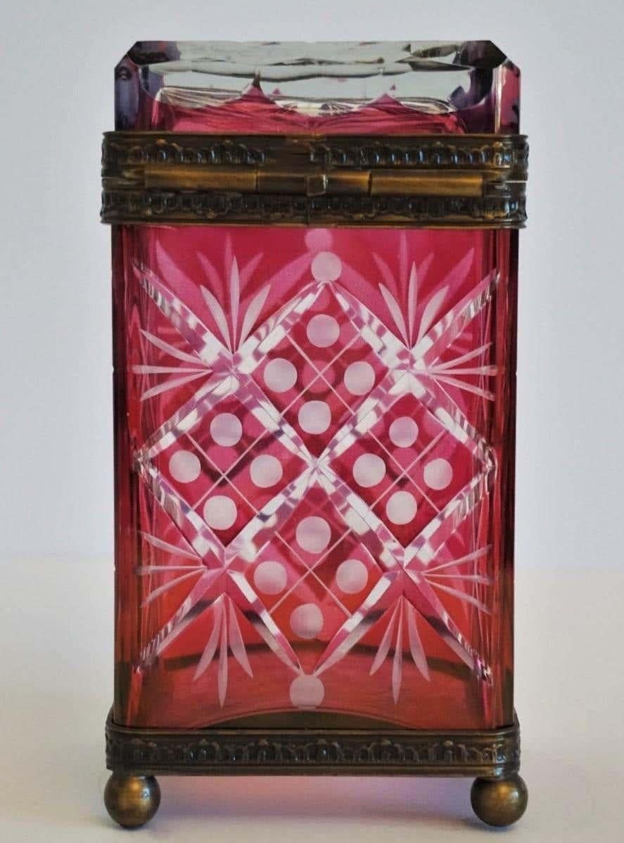 A Victorian style ruby to clear cut crystal box with bronze mounts, France, late 19th century. This beautiful and unique piece is in very good condition.
Measures:
Height 7.25 in (18 cm)
Width 3.75 in (9.5 cm)
Depth 3.75 in (9.5 cm).