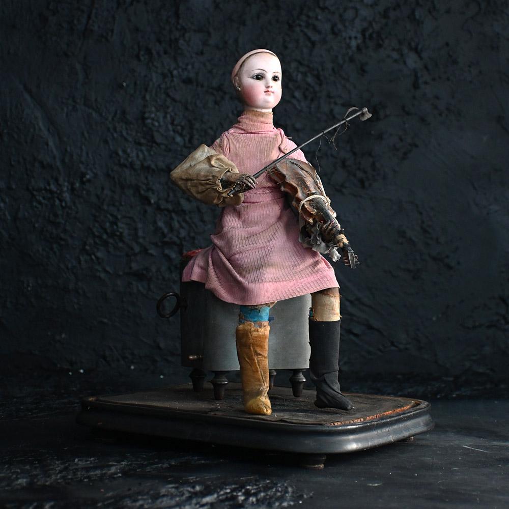 19th Century French Violinist automaton with dome

This original and well-aged late 19th Century French automaton has most certainly seen better days. Dated to the 1870 – 1880s, this clockwork musical antique figure still holds a tune if somewhat