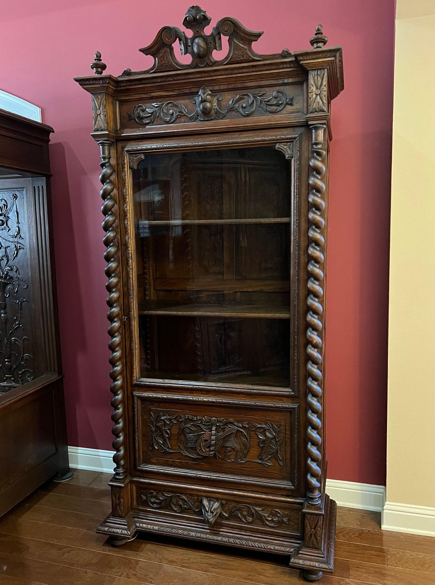 Antique French Vitrine Cabinet Bookcase Barley Twist Black Forest Carved Oak.
 
Direct from France, a stunning antique French bookcase/cabinet, with an unusually SLENDER profile, yet very tall and majestic (7 ft) and completely covered with