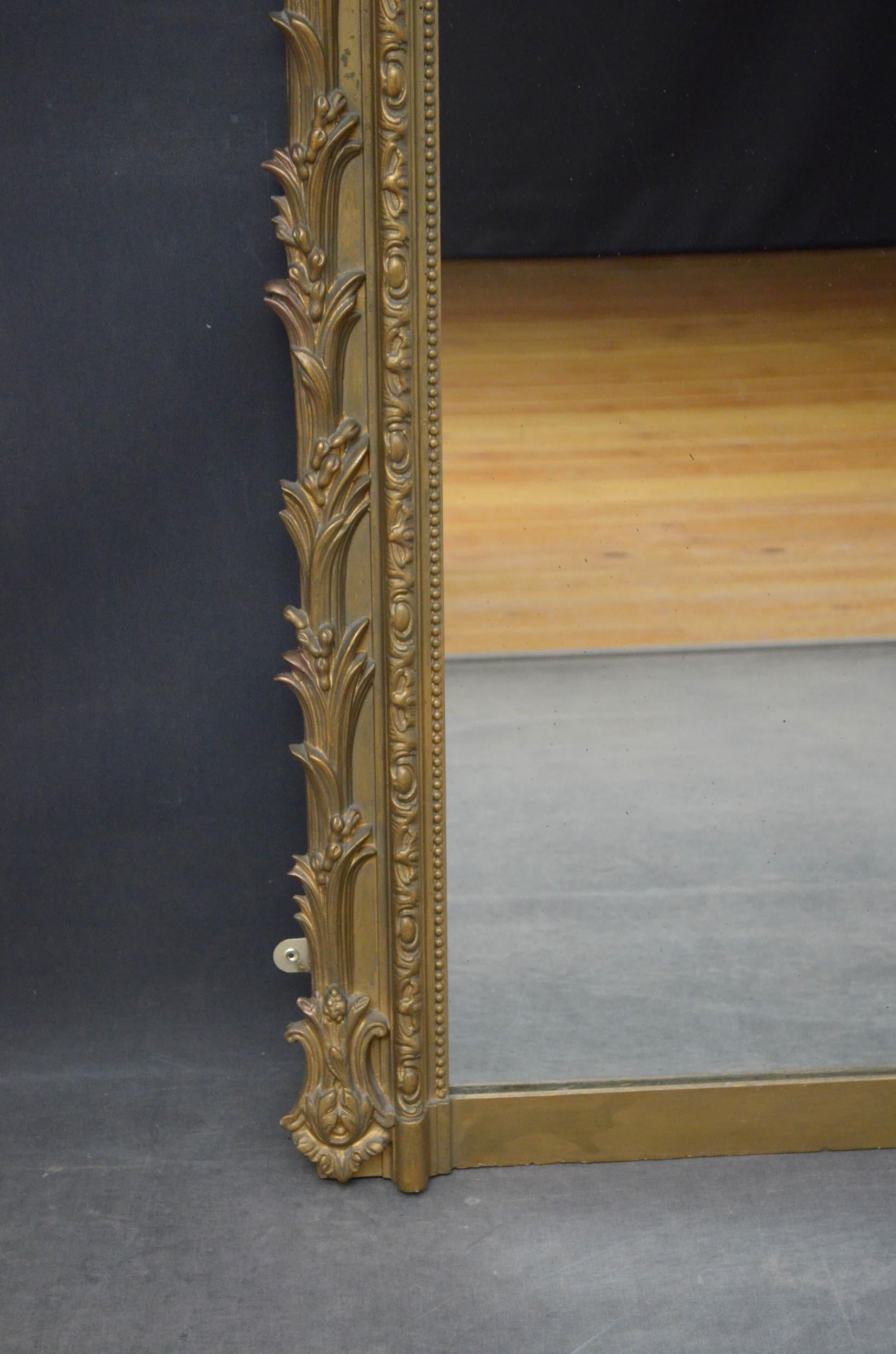 Sn4903 attractive giltwood wall mirror, having original glass with some imperfections in beaded and carved frame with leaf decoration throughout. This antique mirror retains its original glass and backboards with some refinishing, all in home ready
