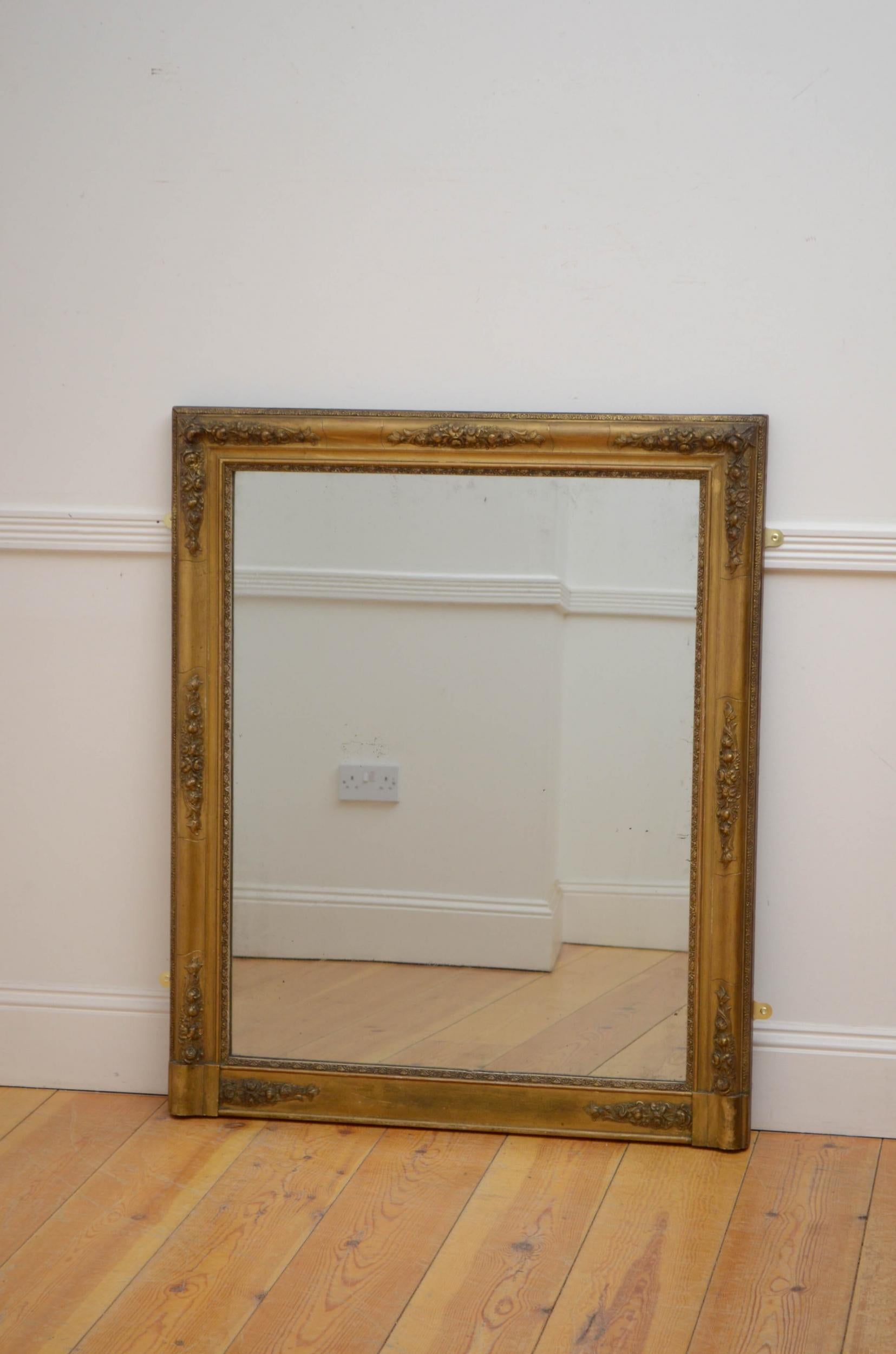 Sn5104 Simple and elegant French giltwood mirror, having original foxed glass in moulded and flower carved frame. This antiuqe mirror retains its original glass and original backboards with some refinishing to the gilt, all in wonderful home ready