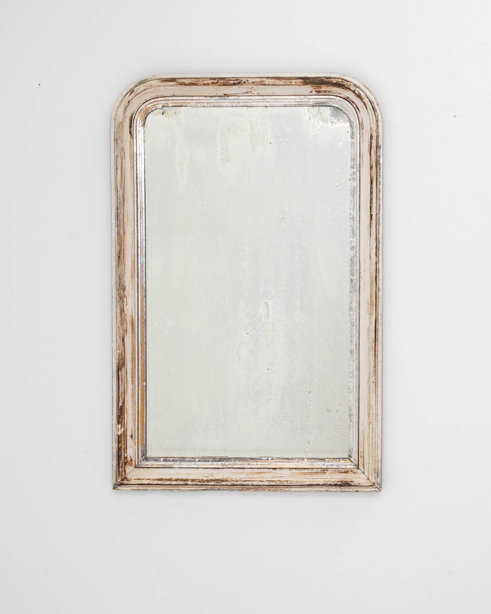Graceful yet restrained, this antique wooden wall mirror has a serene simplicity. Made in France in the 1800s, the design reflects the stripped-back elegance of Louis Philipe style. The rounded upper corners of the frame bring elegance to the form,